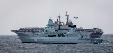 The German Sachsen-class air-defense frigate FGS Sachsen (F 219), front, and Wasp-class amphibious assault ship USS Kearsarge (LHD 3) transit in formation in the North Atlantic Ocean in support of exercise Northern Viking 22.