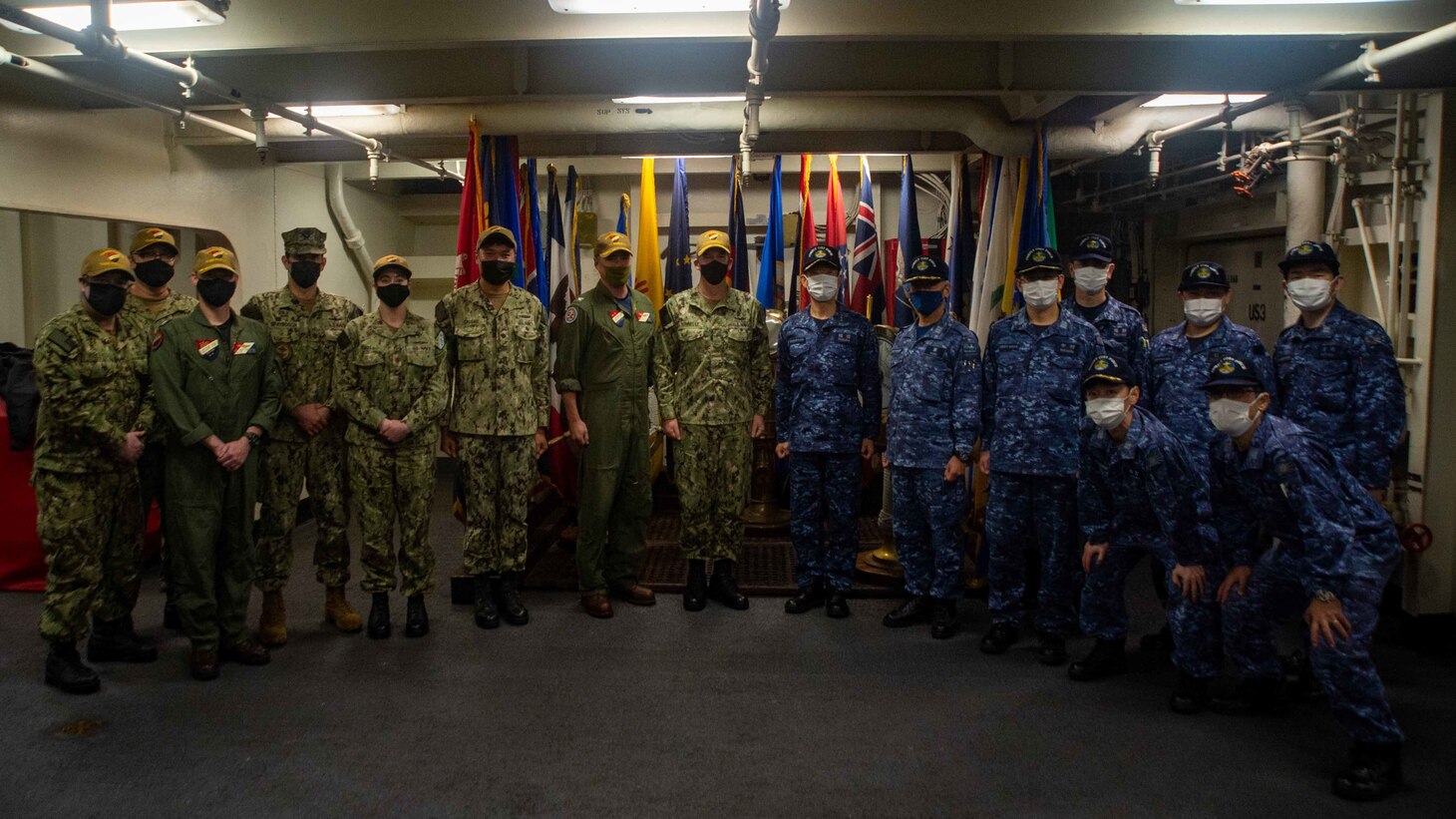 YOKOSUKA, Japan (April 15, 2022) Japan Maritime Self-Defense Force and Commander, Task Force (CTF) 70 staff pose for a group photo following Flag Talks aboard the U.S. Navy’s only forward-deployed aircraft carrier, USS Ronald Reagan (CVN 76), flagship of Carrier Strike Group (CSG) 5. Flag talks allow commanders to plan for future operations, work through challenges or lessons learned, while building towards greater collaboration when their forces operate together in the maritime environment. CTF 70/CSG 5 is forward-deployed to the U.S. 7th Fleet area of operations in support of a free and open Indo-Pacific (U.S. Navy photo by Mass Communication Specialist 2nd Class Askia Collins)