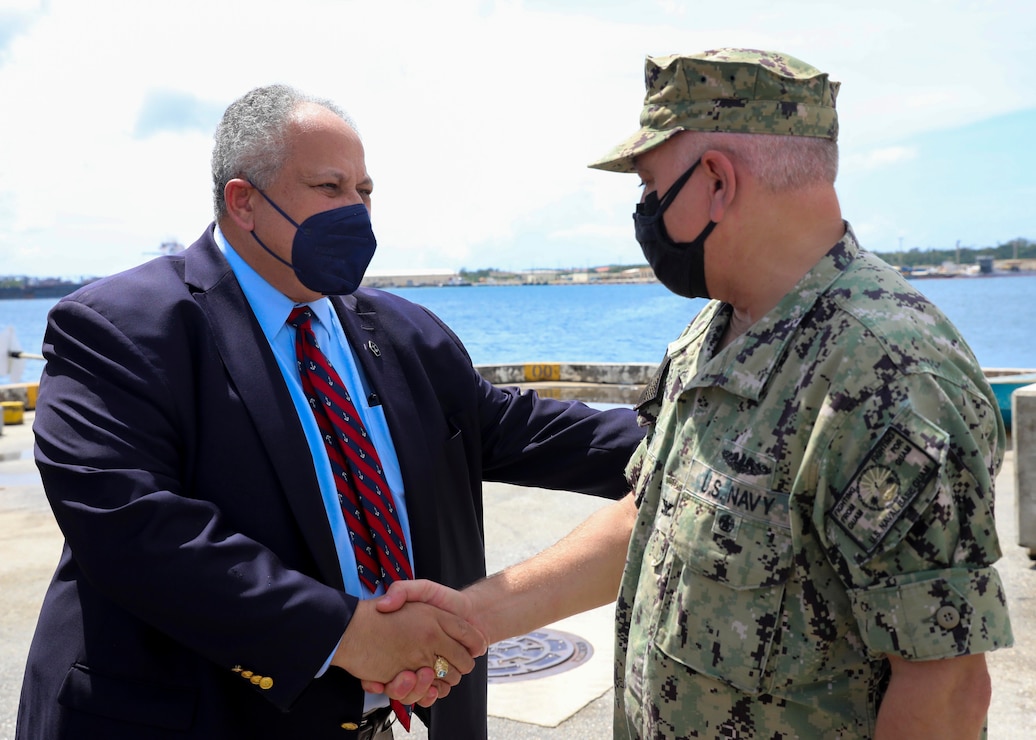 Secretary of the Navy Carlos Del Toro greets Capt. Michael Luckett, commanding officer of U.S. Naval Base Guam, on the pier during a tour of the base, Oct. 30.