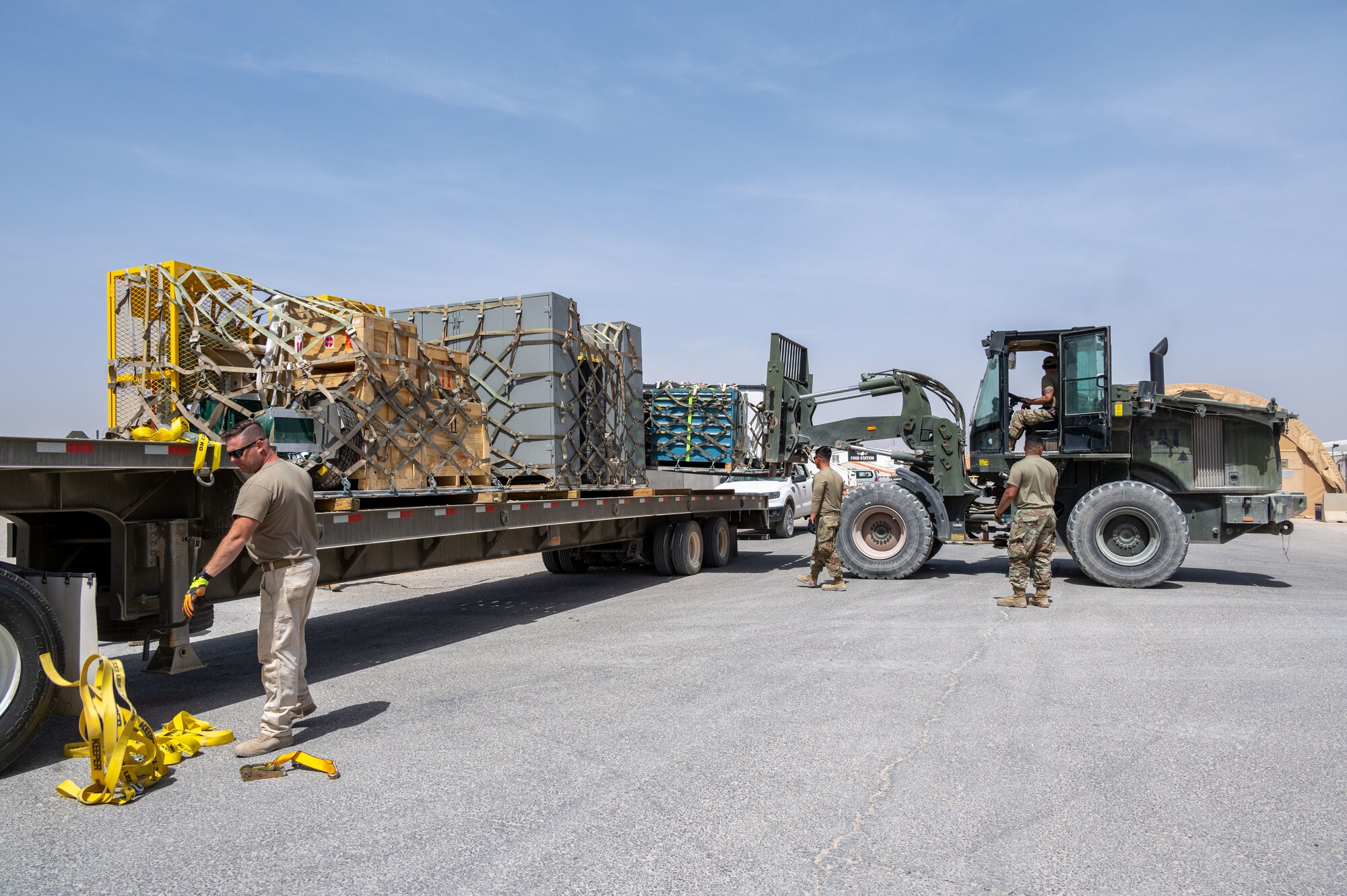 The 332d Expeditionary Logistics Readiness Squadron Traffic Management Operations Airmen unload newly arrived cargo at an undisclosed location in Southwest Asia, April 9, 2022. The 332d ELRS provides premier combat sustainment operations to AFCENT's primary combat wing in order to deter and defeat regional aggressors.