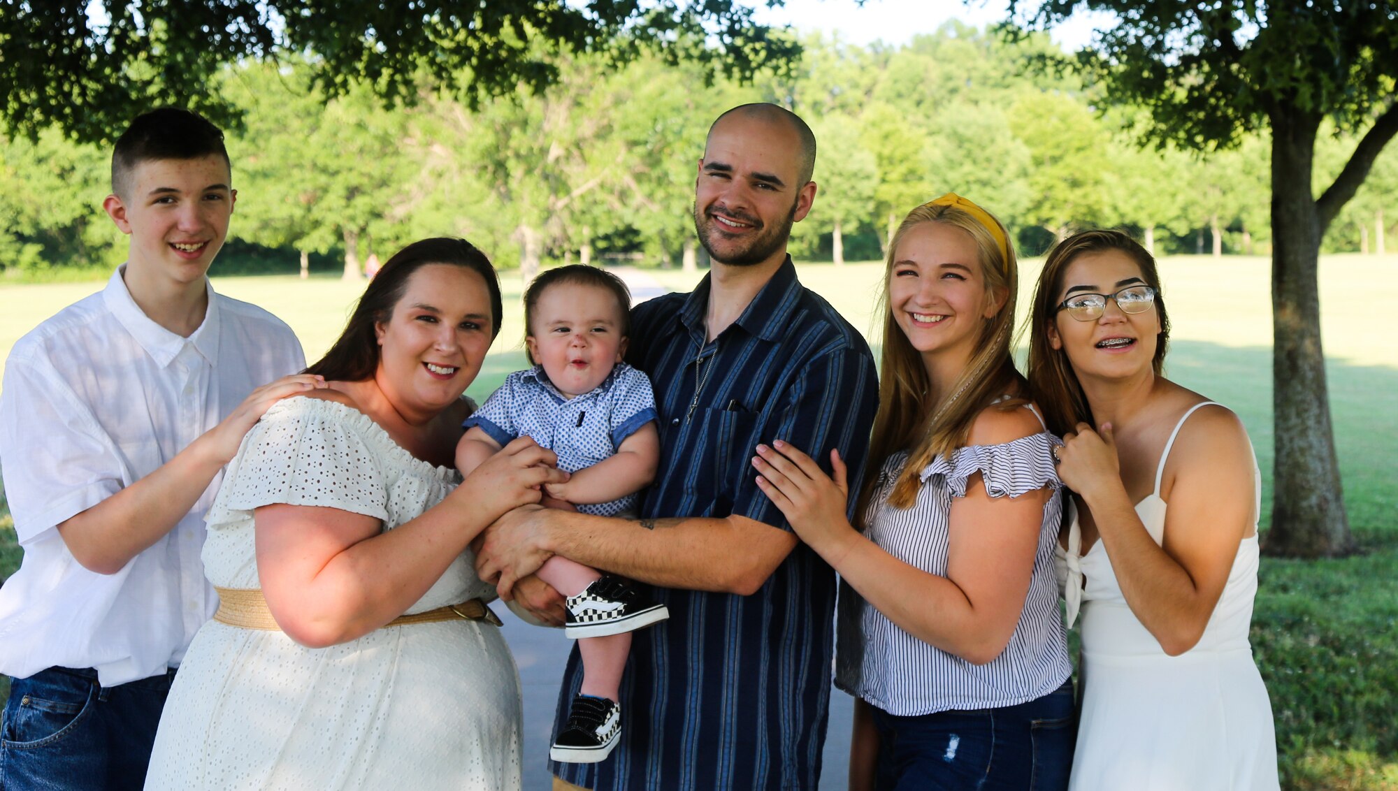 Senior Airman James Douds, 51st Logistics Readiness Squadron petroleum, oils and lubricants (POL) journeyman, smiles with his family.