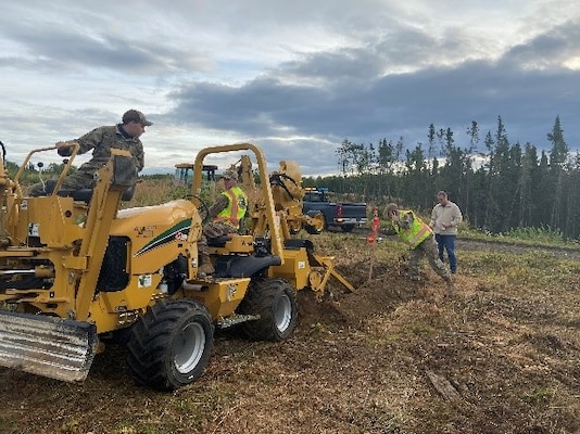 Members of the U.S. Air Force 773 Civilian Engineering Squadron utilize a Vermeer RTX 550 trencher, along with a John Deere 410G Backhoe, to remove several tree stumps and produce a relatively straight-line path away from the loop road in which the sensing cable was buried. The U.S. Army Engineer Research and Development Center’s Cold Regions Research and Engineering Laboratory successfully demonstrated groundbreaking technology to detect airborne targets during a multi-service exercise
