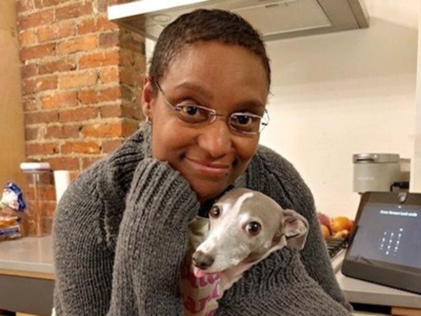 Lt. Col. Traci Willie at home just after treatment and surgery with her pup Taussey in Dec of 2020.