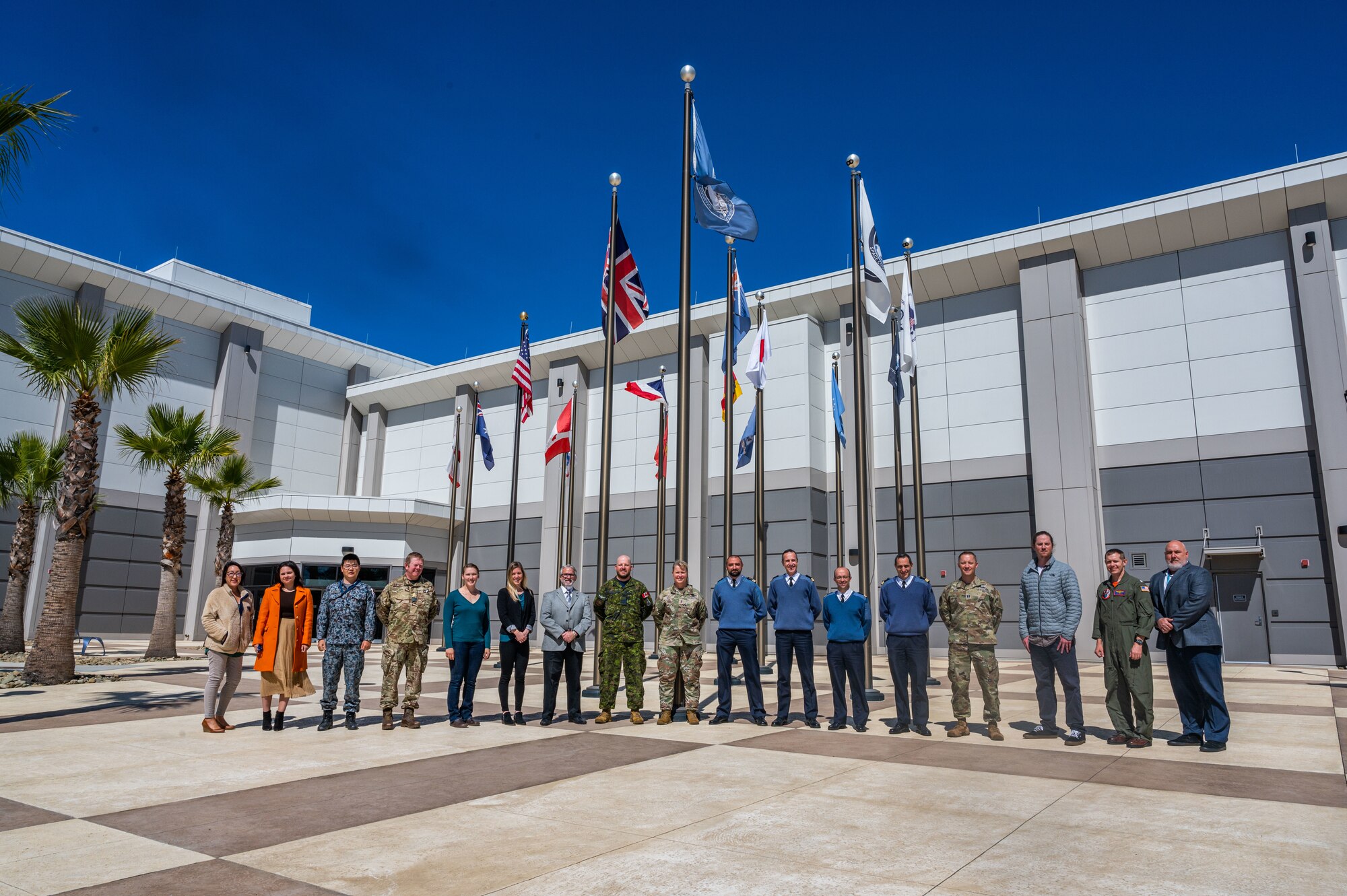 The commander of the Combined Force Space Component Command, Maj. Gen. DeAnna Burt, center, stands for a photo in front of the CFSCC headquarters building with French Space Command officers and French Armed Forces Joint Head Quarters, as well as the U.S. Space Command’s Multinational Space Collaboration office team, Apr. 15, 2022, at Vandenberg Space Force Base, Calif. The French officers pictured with Burt are Lt. Col. Yann Roberge, Col. Guillaume Bourdeloux, Col. Laurent Rigal, and Col. Sebastien Alvarez. The delegation of French officers spent a week with USSPACECOM, CFSCC, the Combined Space Operations Center, and the 18th Space Defense Squadron to become more familiar with Operation OLYMPIC DEFENDER mission areas, and to discuss potential future operational support and partnership opportunities in the space domain. The French Space Command stood up in September 2019 and is in charge of operations support, space service support and space defense. (U.S. Space Force photo by Tech. Sgt Luke Kitterman)