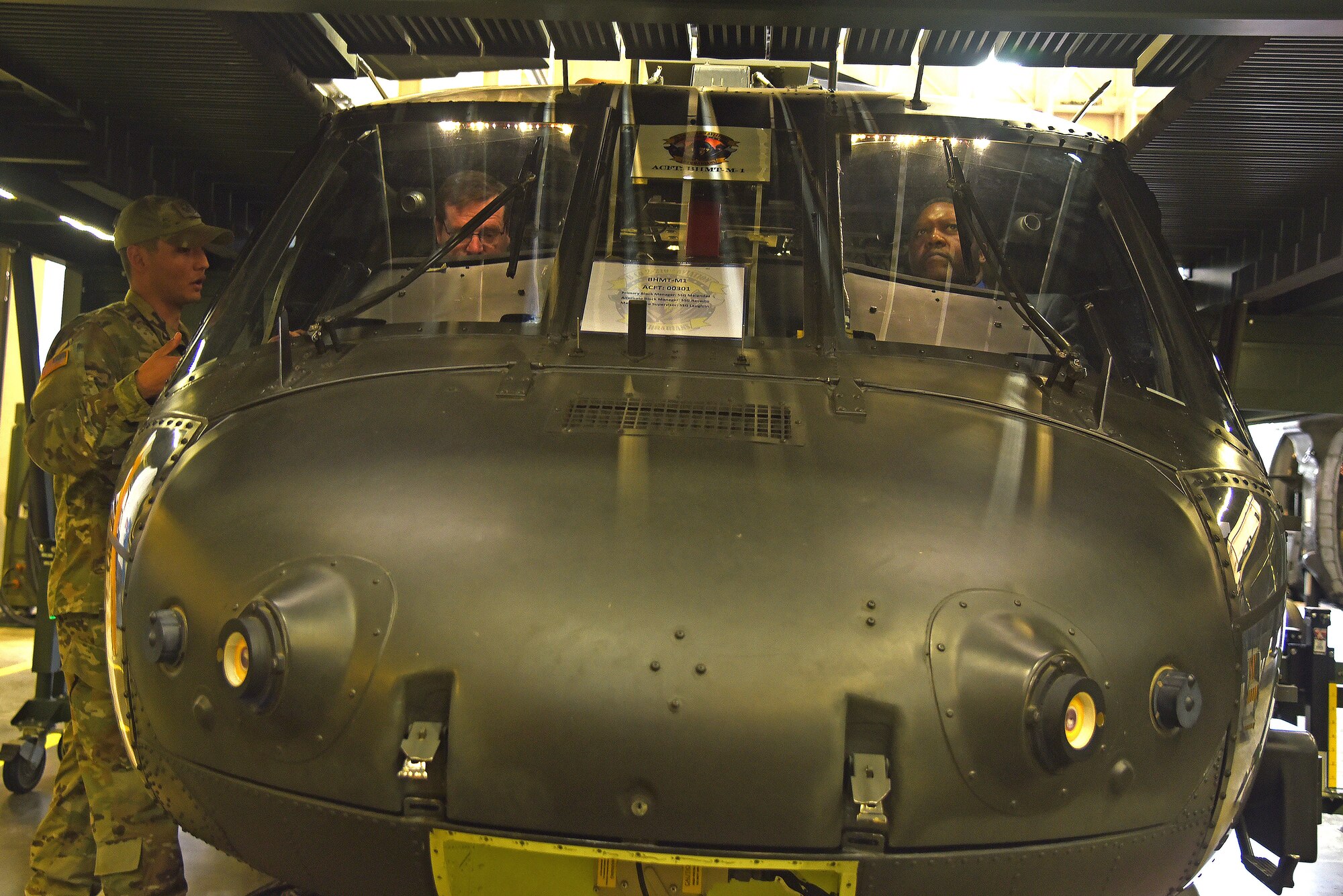 Gene Garland and Drew Lumpkin sit in a helicopter.