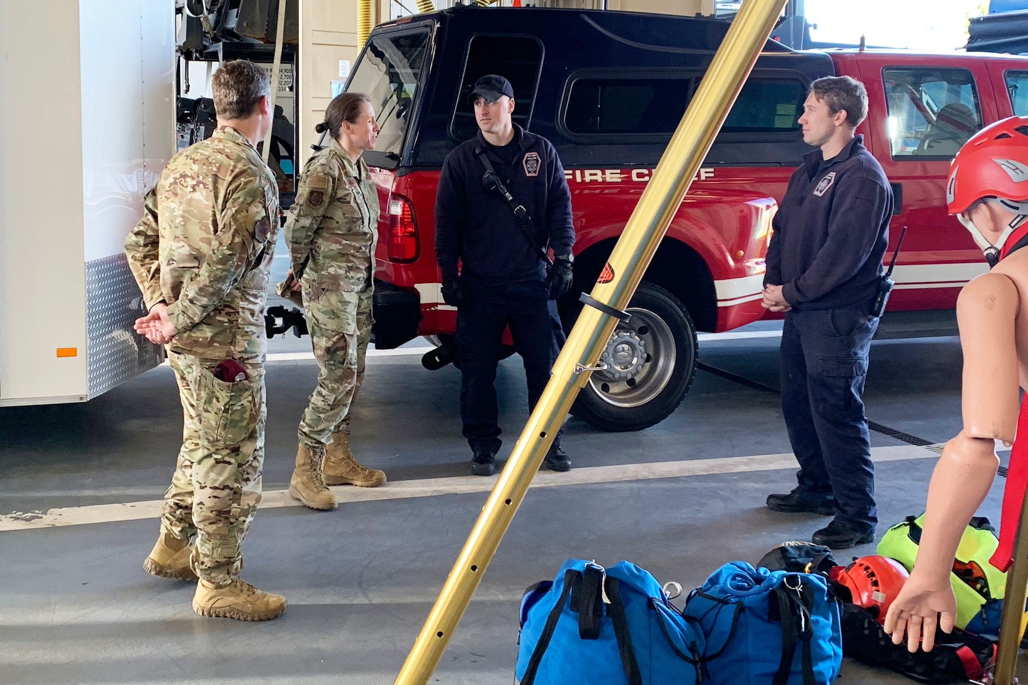 Mr. Brandon Ehlers, New York State Fire Fighter and Mr. Mathew Palmer, New York State Fire Fighter, speaks to Brig. Gen. Denise Donnell, the commander of the New York Air National Guard, about the 106th Civil Engineer urban search & rescue extraction team at Francis S. Gabreski ANGB, Westhampton Beach, N.Y., April 8, 2022. Urban search & rescue extraction team can be called on to respond to New York State domestic emergencies. (U.S. Air National Guard photo by Lt. Cheran A. Campbell)