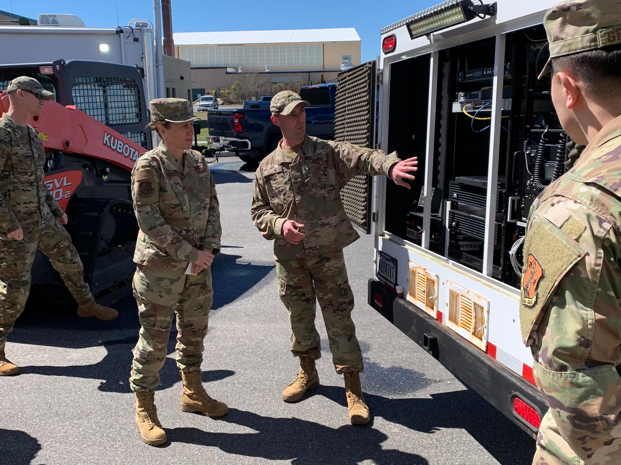 Master Sgt. Brian Dillon, 106th Communication Flight client systems technician supervisor, explains the importance of the Mobile Emergency Response Center to Brig. Gen. Denise Donnell, the commander of the New York Air National Guard at Francis S. Gabreski ANGB, Westhampton Beach, N.Y., April 8, 2022. The Mobile Emergency Response Center is used when officials and responders need to establish reliable communication or extend their range of communication. (U.S. Air National Guard photo by Lt. Cheran A. Campbell)
