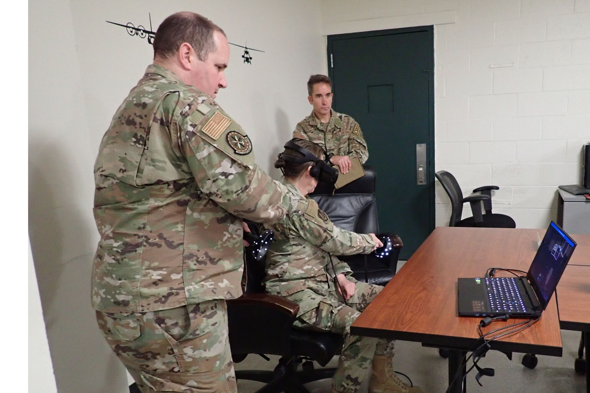 Master Sgt. Thomas Beall, 106th Rescue Wing aerospace propulsion superintendent, instructs Brig. Gen. Denise Donnell, the commander of the New York Air National Guard, on how to use the virtual reality Engine Run program at Francis S. Gabreski ANGB, Westhampton Beach, N.Y., April 8, 2022. The maintenance group is testing out a virtual reality Engine Run program, that teaches maintainers how to start and shutdown engines in accordance with their regulations through a virtual world. (U.S. Air National Guard photo by Lt. Cheran A. Campbell)