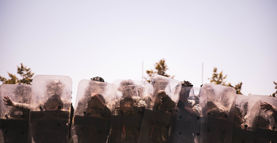 Marines with 2nd Battalion, 5th Marine Regiment, 1st Marine Division advance as a riot control unit during the I Marine Expeditionary Force Non-Lethal Weapons Course on Camp Pendleton, Calif., April 7, 2022. During the course, instructors with Expeditionary Operations Training Group, I Marine Expeditionary Force taught the Marines to execute various riot control drills in order to support crisis response, embassy reinforcement, as well as noncombatant evacuation operations in the future.