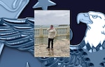 A woman poses in front of the ocean.