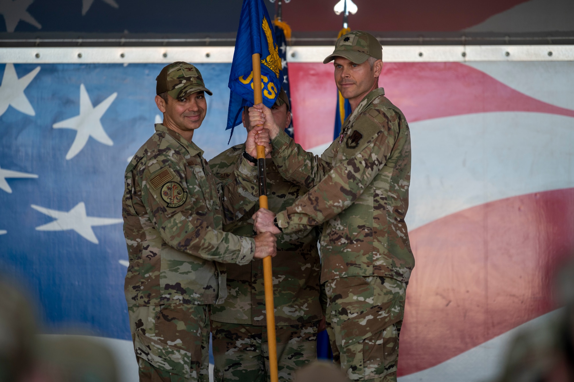 Lt. Col. Jonathan Barber, right, outgoing 4th Operational Support Squadron commander, relinquishes the guidon to Col. Michael Alfaro, 4th Operations Group commander, during the 4th OSS change of command ceremony at Seymour Johnson Air Force Base, North Carolina, April 15, 2022. The passing of a unit's guidon symbolizes a transfer of command. (U.S. Air Force photo by Senior Airman Kevin Holloway)