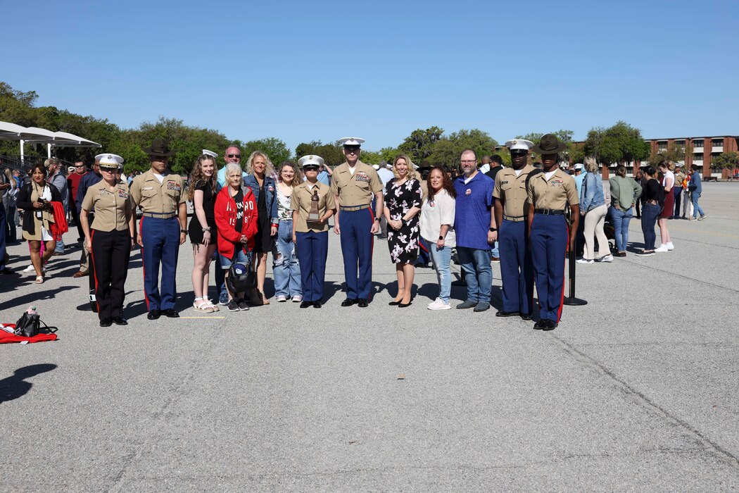 U.S. Marine Corps Sgt. Maj. Troy E. Black, the 19th Sergeant Major of the Marine Corps, poses for a photo with the Lima Company honor graduate at Marine Corps Recruit Depot Parris Island, South Carolina, April 7, 2022. The sergeant major of the Marine Corps and his spouse, retired First Sgt. Stacie Black were the parade reviewing officials for Lima Company graduation ceremony. Marine Corps Recruit Depot Parris Island has transformed young men and women into Marines since 1915. (U.S. Marine Corps photo by Staff Sgt. Victoria Ross)