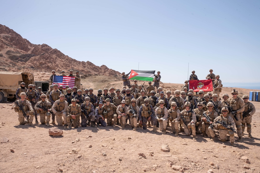U.S. Marines assigned to Fox Company, 2nd Battalion, 24th Marines, Jordanian Marines from the 77th Royal Jordanian Marine Battalion, and members of the 61st Quick Reaction Force Battalion, King Abdullah II Special Forces Group pose for a photo during exercise Intrepid Maven (IM) 22-1 aboard Camp Titin, Jordan, March 18. IM is a bilateral engagement series between U.S. Marine Corps Forces, Central Command and the Jordanian Armed Forces (JAF) that provides an opportunity to exchange military tactics and expertise. IM 22-1 is the first of multiple engagements scheduled between the U.S. Marine Corps and the JAF to increase interoperability, strengthen our enduring partnership, deter malign actors in the region, and ensure optimal readiness to respond to a variety crisis and contingency operations in the U.S. Central Command area of responsibility. (U.S. Marine Corps photo by Cpl. James Stanfield)