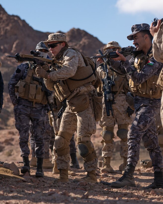 U.S. Marines with 2nd Battalion, 24th Marines and Jordanian Marines from the 77th Royal Jordanian Marine Battalion compete in an ammunition speed reload challenge during exercise Intrepid Maven (IM) 22-1, aboard Camp Titin, Jordan, March 15. IM is a bilateral engagement series between U.S. Marine Corps Forces, Central Command and the Jordanian Armed Forces (JAF) that provides an opportunity to exchange military tactics and expertise. IM 22-1 is the first of multiple engagements scheduled between the U.S. Marine Corps and the JAF to increase interoperability, strengthen our enduring partnership, deter malign actors in the region, and ensure optimal readiness to respond to a variety crisis and contingency operations in the U.S. Central Command area of responsibility. (U.S. Marine Corps photo by Cpl. James Stanfield)