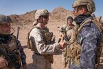 A U.S. Marine assigned to Fox Company, 2nd Battalion, 24th Marines shakes hands with a Jordanian Marine from the 77th Royal Jordanian Marine Battalion after the final exercise (FINEX) of Intrepid Maven (IM) 22-1 aboard Camp Titin, Jordan, March 18. IM is a bilateral engagement series between U.S. Marine Corps Forces, Central Command and the Jordanian Armed Forces (JAF) that provides an opportunity to exchange military tactics and expertise. IM 22-1 is the first of multiple engagements scheduled between the U.S. Marine Corps and the JAF to increase interoperability, strengthen our enduring partnership, deter malign actors in the region, and ensure optimal readiness to respond to a variety crisis and contingency operations in the U.S. Central Command area of responsibility. (U.S. Marine Corps photo by Cpl. James Stanfield)