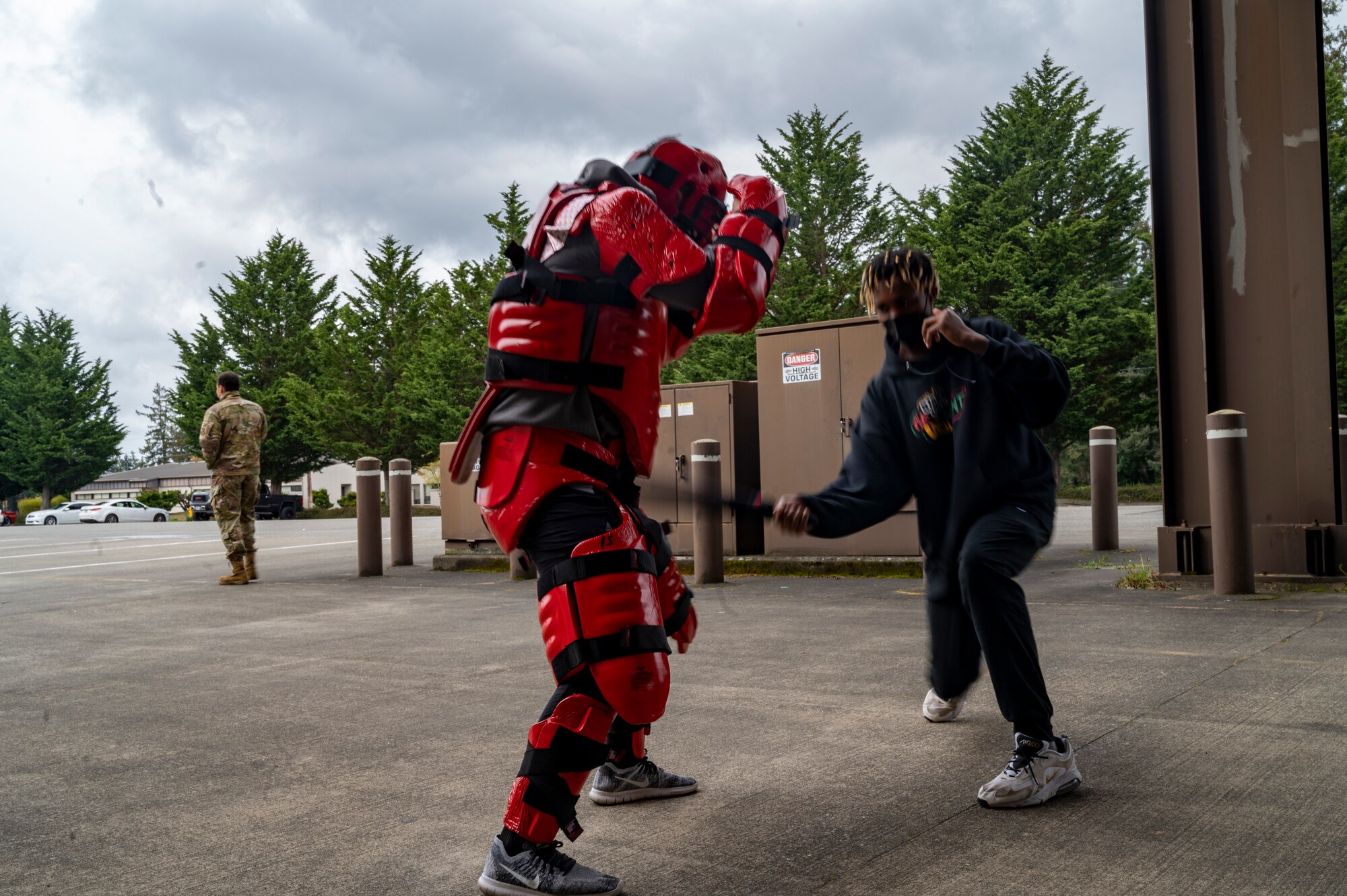 A member of the Red-Tailed Hawks Youth Program practices using a security forces baton during the Aviation Inspiration and Mentorship (AIM) Wing event at Joint Base Lewis-McChord, Washington, April 16, 2022. AIM Wing is an community outreach program with a mission to inform, influence and inspire the next generation of Air Force aviators. (U.S. Air Force photo by Airman 1st Class Charles Casner)