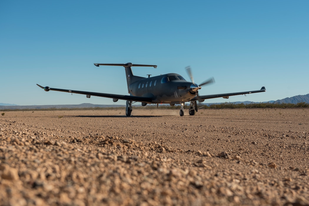 A U-28 taxis along a dirt runway