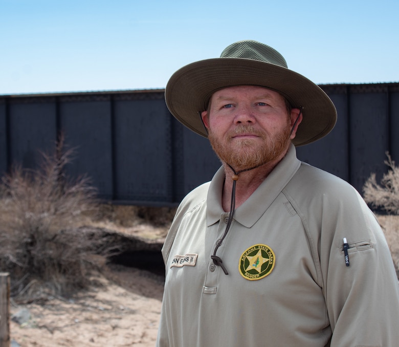 Arizona State Park Ranger Kenneth ‘Kenn’ Evans II stands in front of salt cedar at the banks of the Little Colorado River April 11 in Winslow, Arizona. Evans described the negative impacts salt cedar has on flood control and prevention methods in Navajo County, prior to a project site visit and panel presentation about the Little Colorado River at Winslow Flood-Control Project. (Photo by Robert DeDeaux, Los Angeles District PAO)