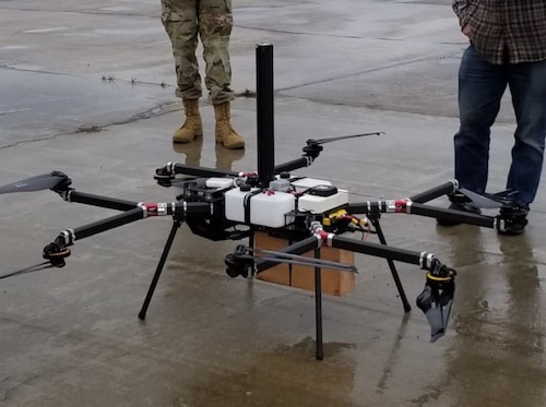Members of Program Executive Office Digital’s Aerospace Management Systems Division inspect a Precision Automated Instrumented Landing Survey, or PAISLEY, unmanned aerial system prototype.