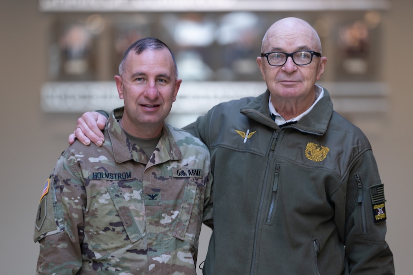 U.S. Army Central, Col. Joel Holmstrom stand next to his father, retired Army Maj. Robert Holmstrom.
