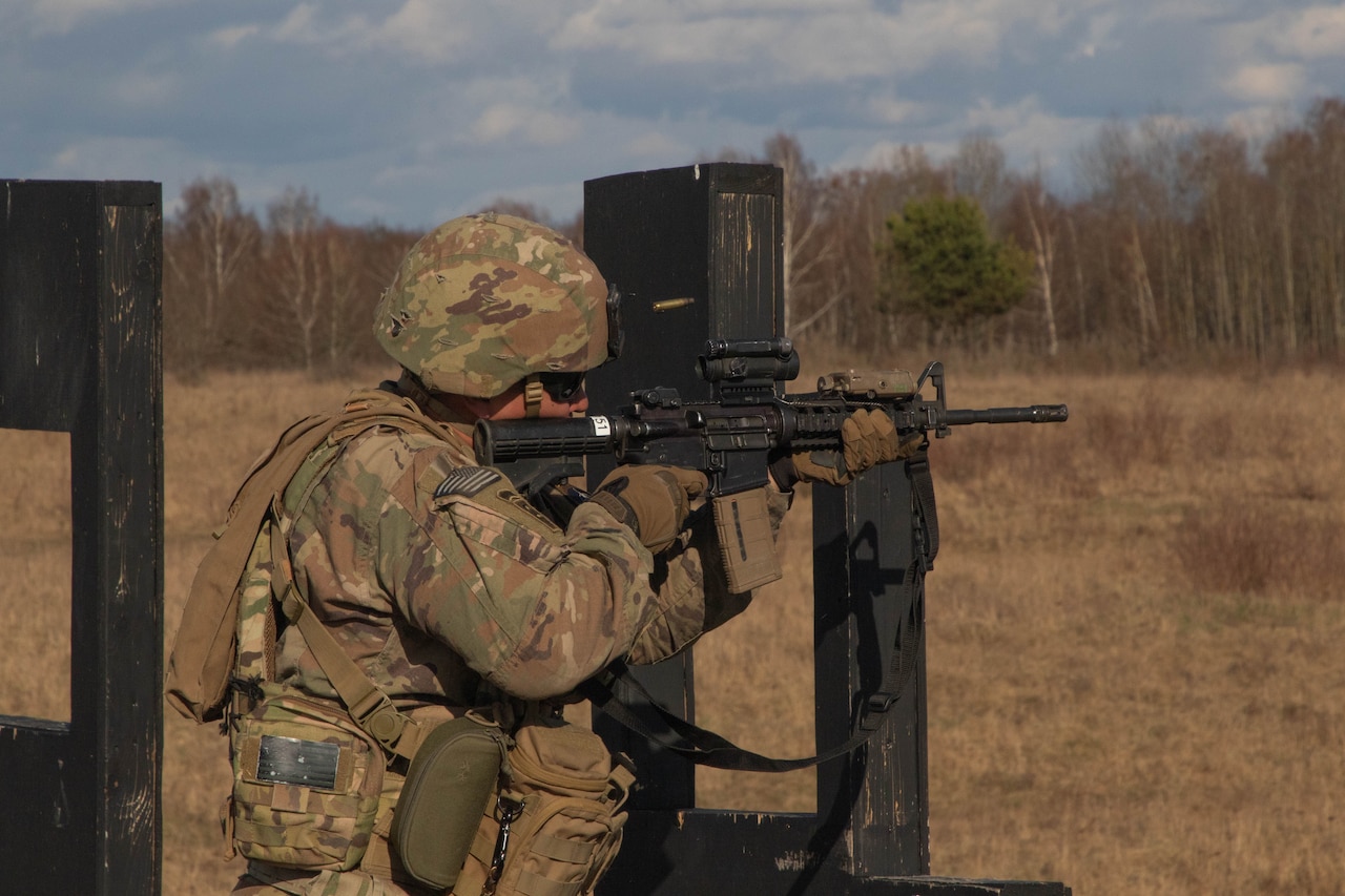 A soldier fires a gun.