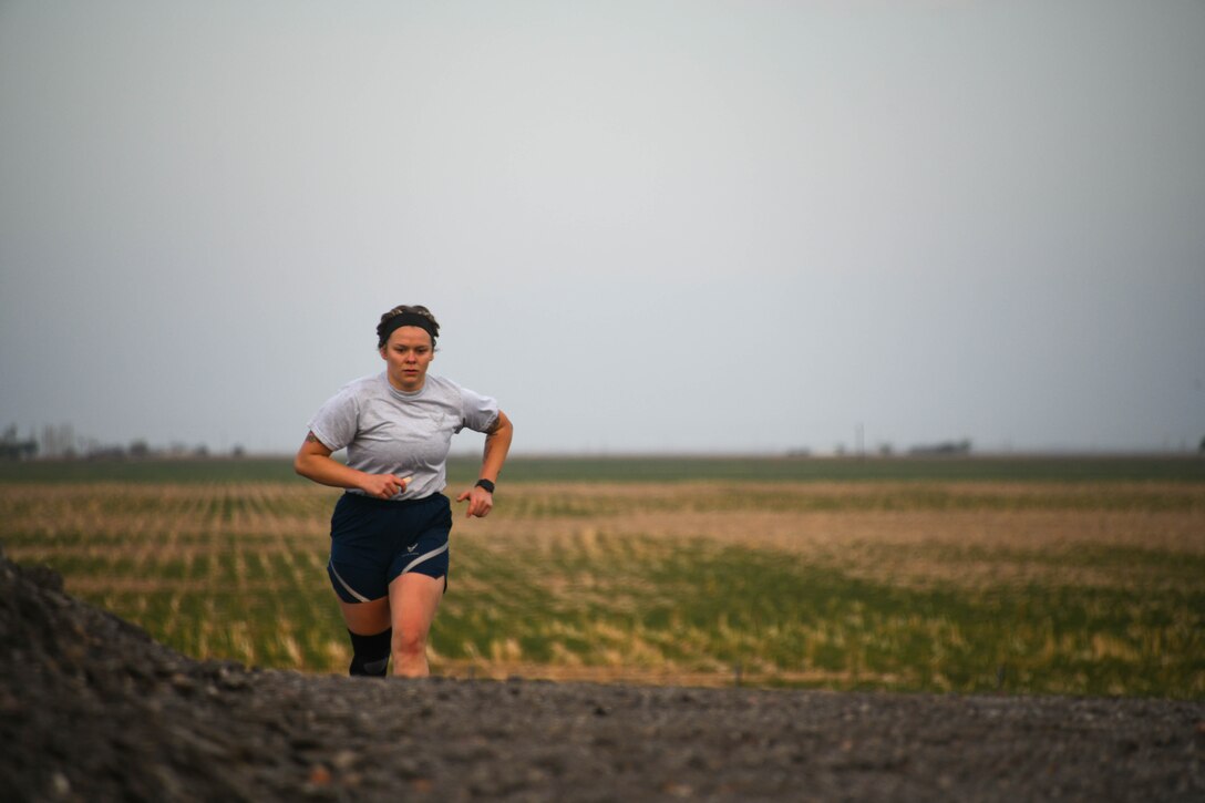U.S. Air Force Airman 1st Class Kylie Sullivan, 97th Training Squadron (TRS) aircrew student in training, runs up a hill during the Talon Challenge at Altus Air Force Base, Oklahoma, April 10, 2022. Sullivan was coined by Lt. Col. Matthew Tarnowski, 97th TRS commander, for her leadership and hard work during the challenge. (U.S. Air Force photo by Airman 1st Class Trenton Jancze)