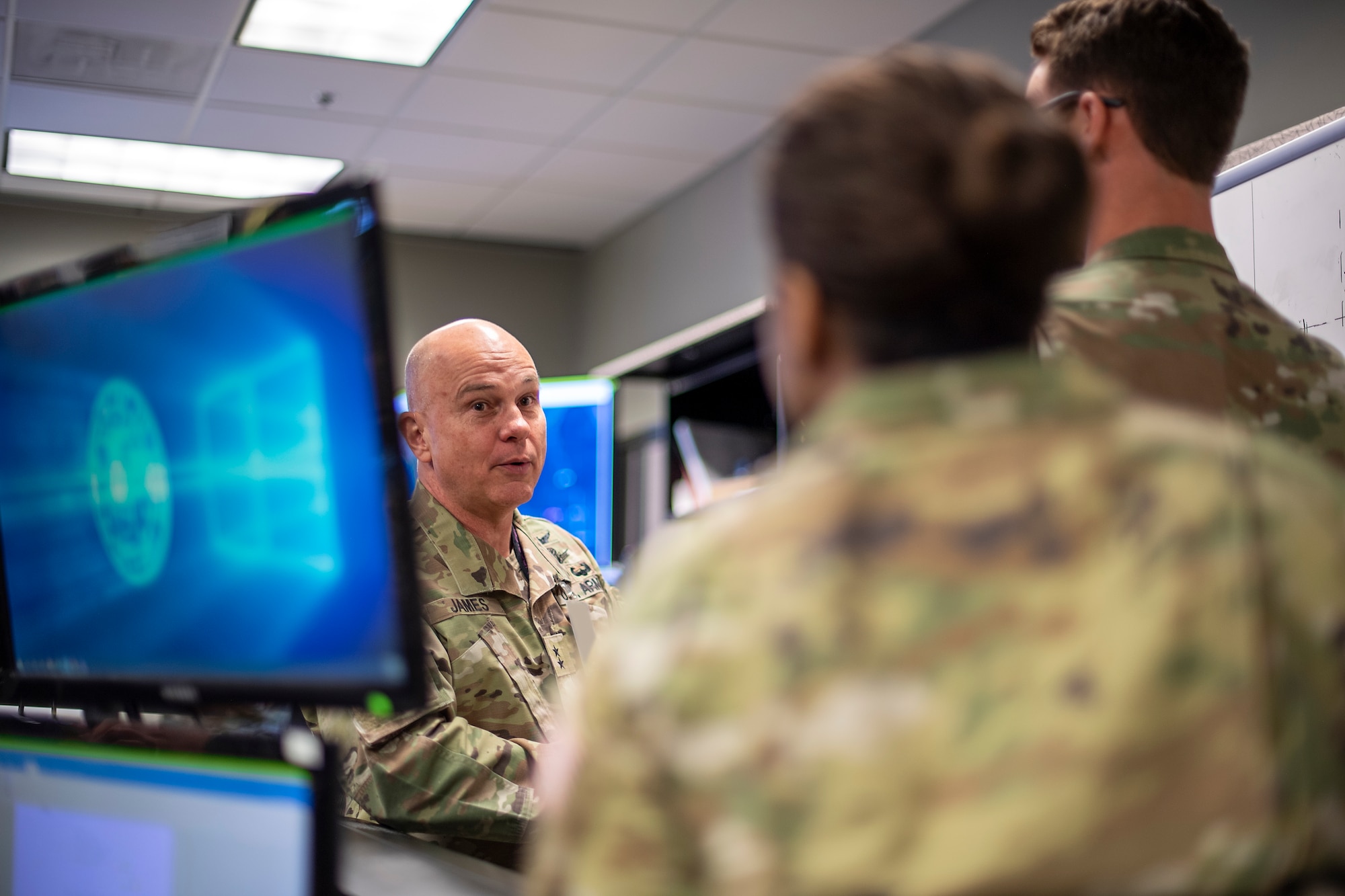 U.S. Army MG Tom James (left) Joint Task Force – Space Defense Commander receives a brief from 1st Lt Andrew Scott (Right) on the military satellite communications and navigation warfare package’s plans during SPACE FLAG 22-2 execution. (U.S. Space Force photo by Ms. Judi Tomich)