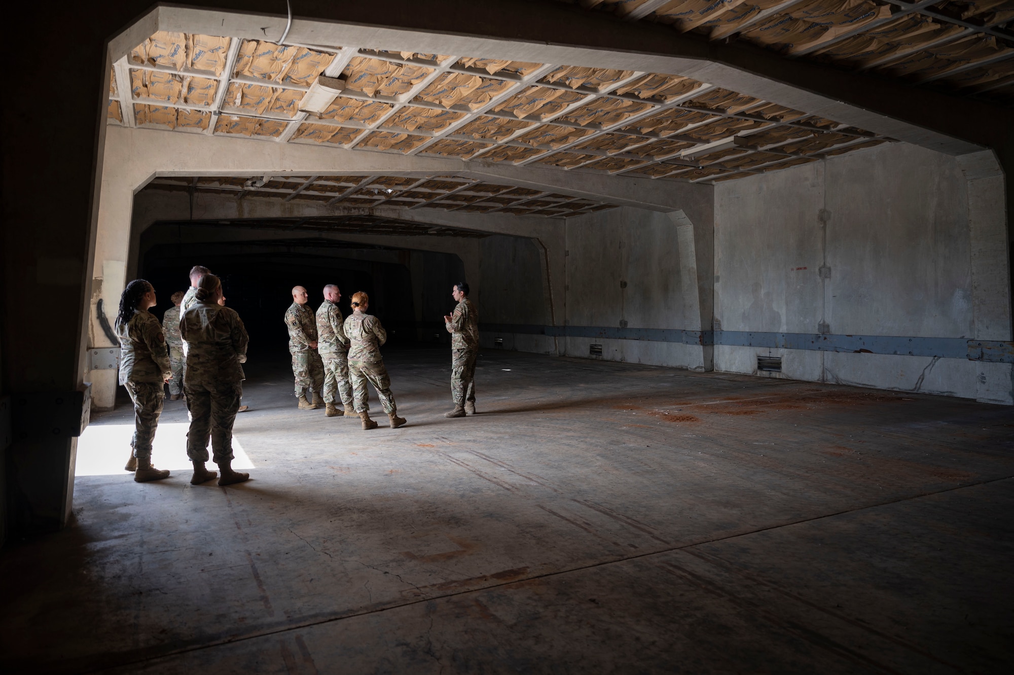 U.S. Air Force Chief Master Sgt. David R. Wolfe, Pacific Air Forces command chief, is briefed by Airmen with the 36th Munitions Squadron as they show him one of many munitions storage buildings at Andersen Air force Base, Guam, April 14, 2022.