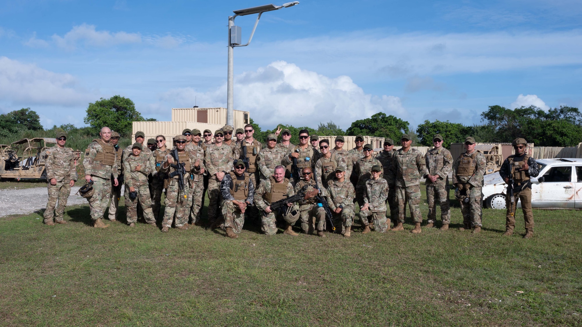 U.S. Air Force Chief Master Sgt. David R. Wolfe, Pacific Air Forces command chief, poses with Airmen with the 36th Security Forces Squadron at Andersen Air Force Base, Guam, April 14, 2022.
