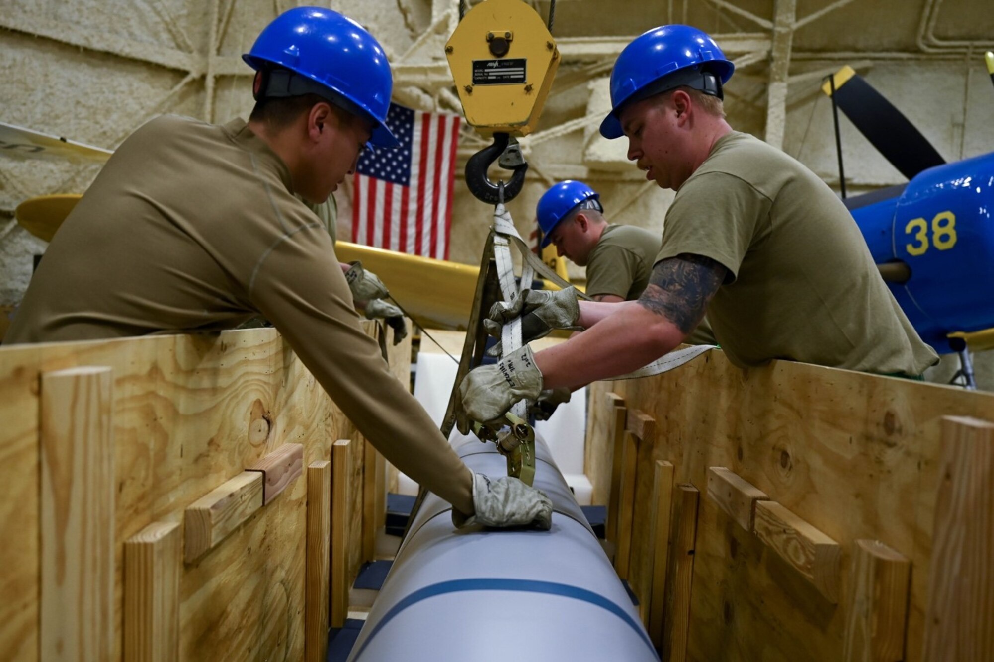 Airmen from the 28th Maintenance Squadron prepare to hang a Joint- Air-to-Standoff Missile in the South Dakota Air and Space Museum, March 5, 2022.