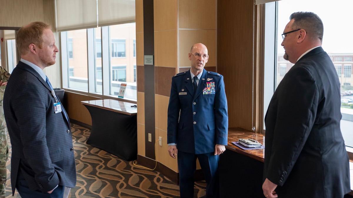 Col. Tory Woodard, center, commander, U.S. Air Force School of Aerospace Medicine, talks to Erik Christensen, right, director of business operations and military affairs, Soin Medical Center; and Daniel Tryon, president of Soin Medical Center and Kettering Health Greene Memorial, during the official opening of the Enlisted Critical Care Course (EECC) at the Soin Medical Center April 13, 2022, in Beavercreek, Ohio. USAFSAM is one of two mission units in the 711th Human Performance Wing, part of the Air Force Research Laboratory (AFRL). AFRL and Kettering Health Network partnered to create a training wing at Soin Medical Center, which allows the Air Force to received training as critical care technicians and also give back to the community. There are 10 courses in a year with 10 technicians each, and the four-week course provides didactics, lectures, simulations and real-patient care. (U.S. Air Force photo / Richard Eldridge)