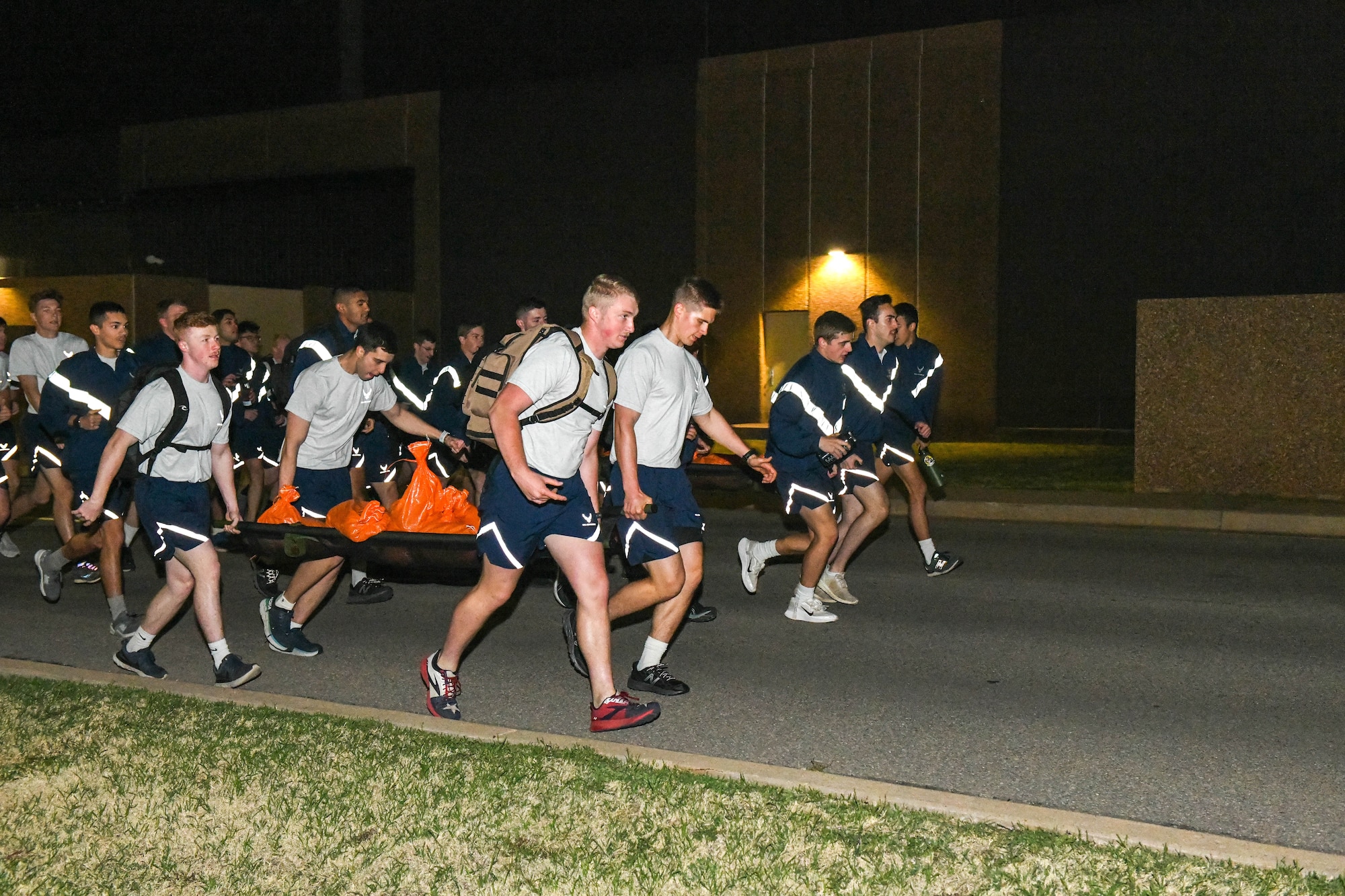 Students from the 97th Training Squadron participate in a 185-pound buddy drag during the Talon Challenge at Altus Air Force Base, Oklahoma, April 10, 2022. Students participated in multiple physical challenges and lectures throughout the day. (U.S. Air Force photo by Airman 1st Class Trenton Jancze)
