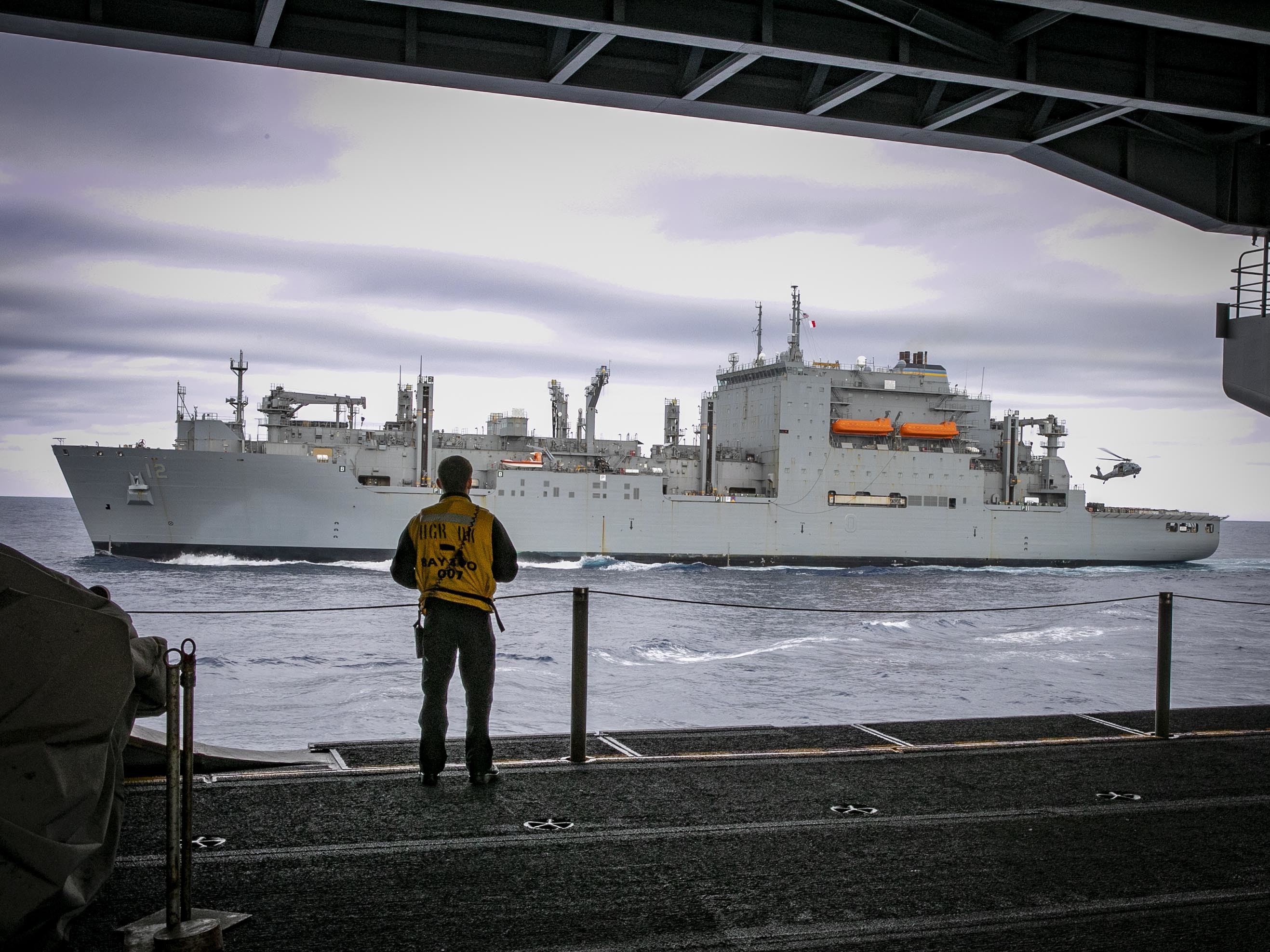 The Military Sealift Command dry cargo ship USNS William Mclean (T-AKE 12) transits alongside the aircraft carrier USS George H.W. Bush (CVN 77) during an ammunition onload, April 16, 2022.