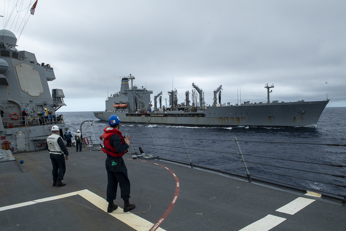 ailors handle line during a replenishment-at-sea with the Henry J. Kaiser-class underway replenishment oiler USNS Tippecanoe (T-AO 199) aboard the Arleigh Burke-class guided-missile destroyer USS Sampson (DDG 102), April 12, 2022.