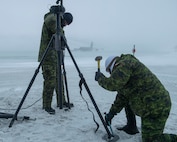 Royal Canadian Air Force servicemembers install communications equipment on the flightline in support of Operation NOBLE DEFENDER at Thule Air Base, Greenland, March 16, 2022.