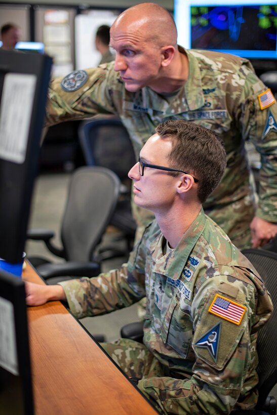 U.S. Space Force 1st Lt Jerrod Mann (Left) 8th Combat Training Squadron and U.S. Space Force 1st Lt Andrew Scott (right) 4th Space Operations Squadron work together to protect military satellite communications assets during SPACE FLAG 22-2. (U.S. Space Force photo by Ms. Judi Tomich)