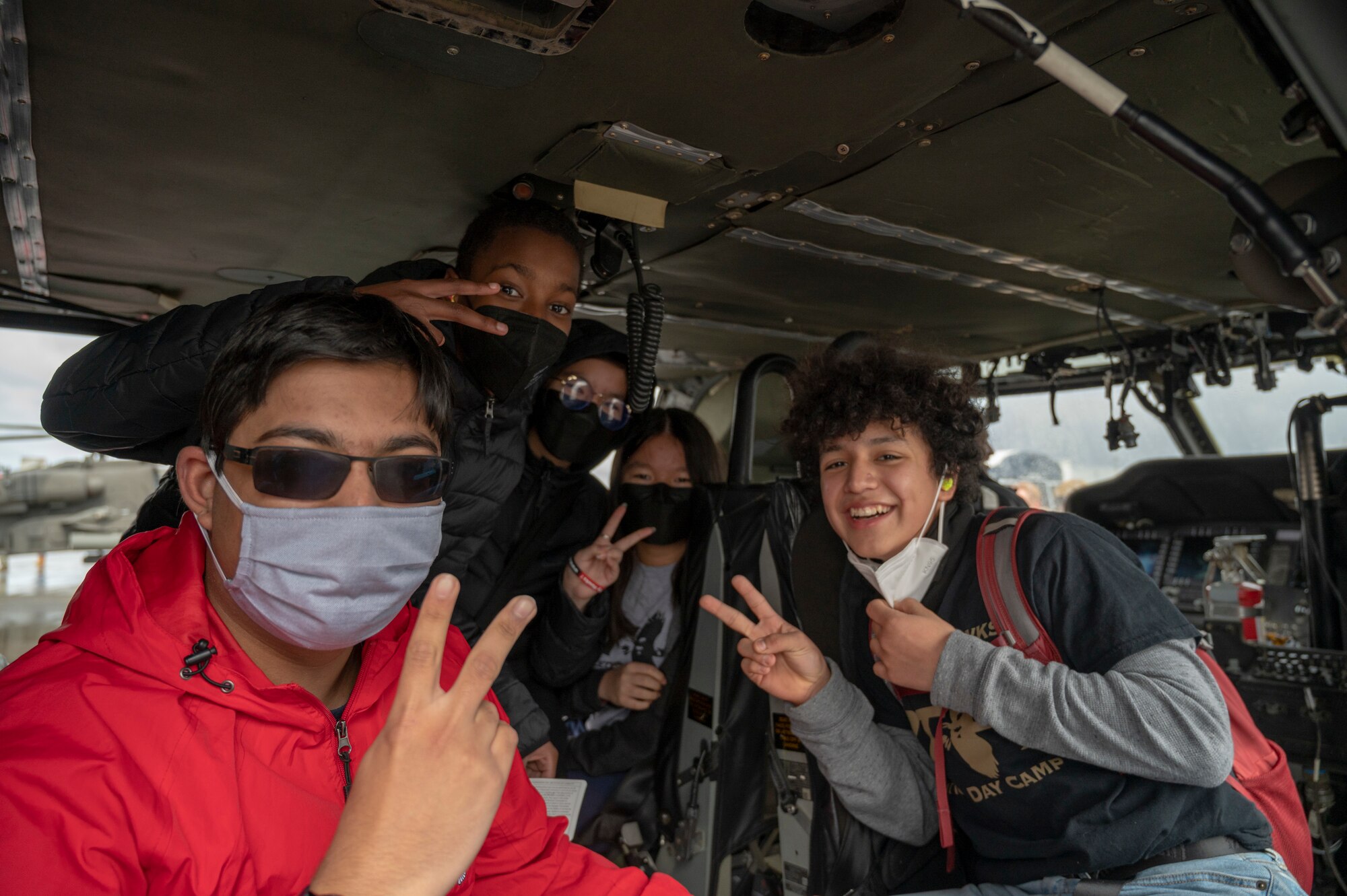 Members of the Red-Tailed Hawks Youth Program sit inside a U.S. Army UH-60M Blackhawk during the Aviation Inspiration and Mentorship (AIM) Wing event at Joint Base Lewis-McChord, Washington, April 16, 2022. AIM Wing is an community outreach program with a mission to inform, influence and inspire the next generation of Air Force aviators. (U.S. Air Force photo by Airman 1st Class Charles Casner)