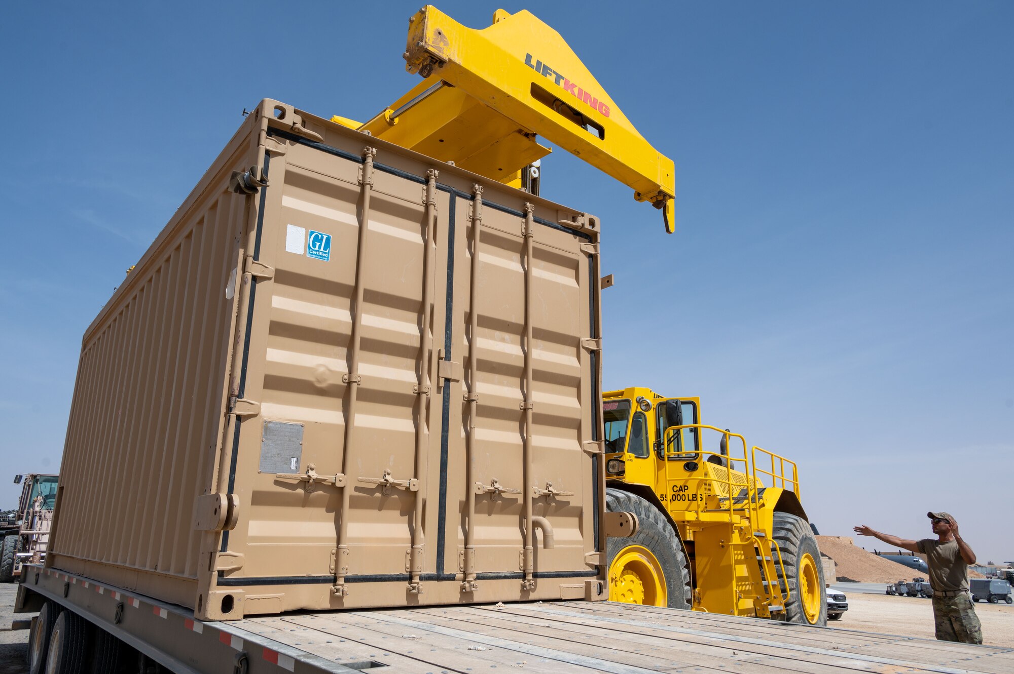 The 332d Expeditionary Logistics Readiness Squadron Traffic Management Operations Airmen prepare to move a shipping container at an undisclosed location in Southwest Asia, April 5, 2022. The 332d ELRS provides premier combat sustainment operations to AFCENT's primary combat wing in order to deter and defeat regional aggressors.
