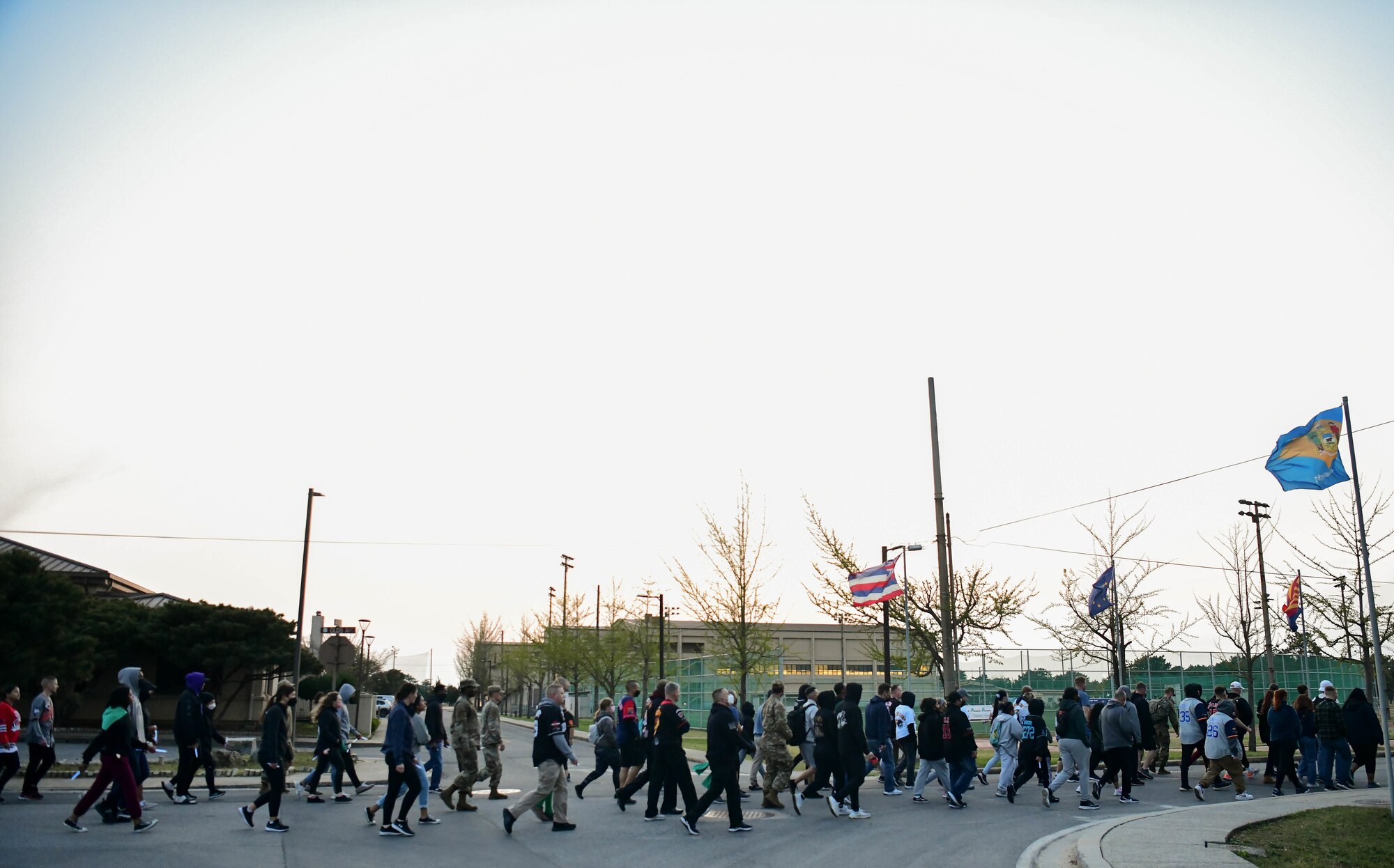 Service members walk during a sexual assault prevention event.