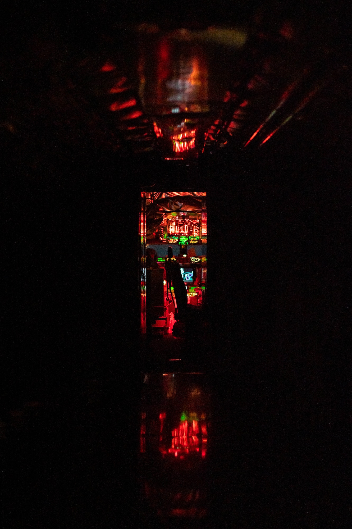 The cockpit glows red in the night