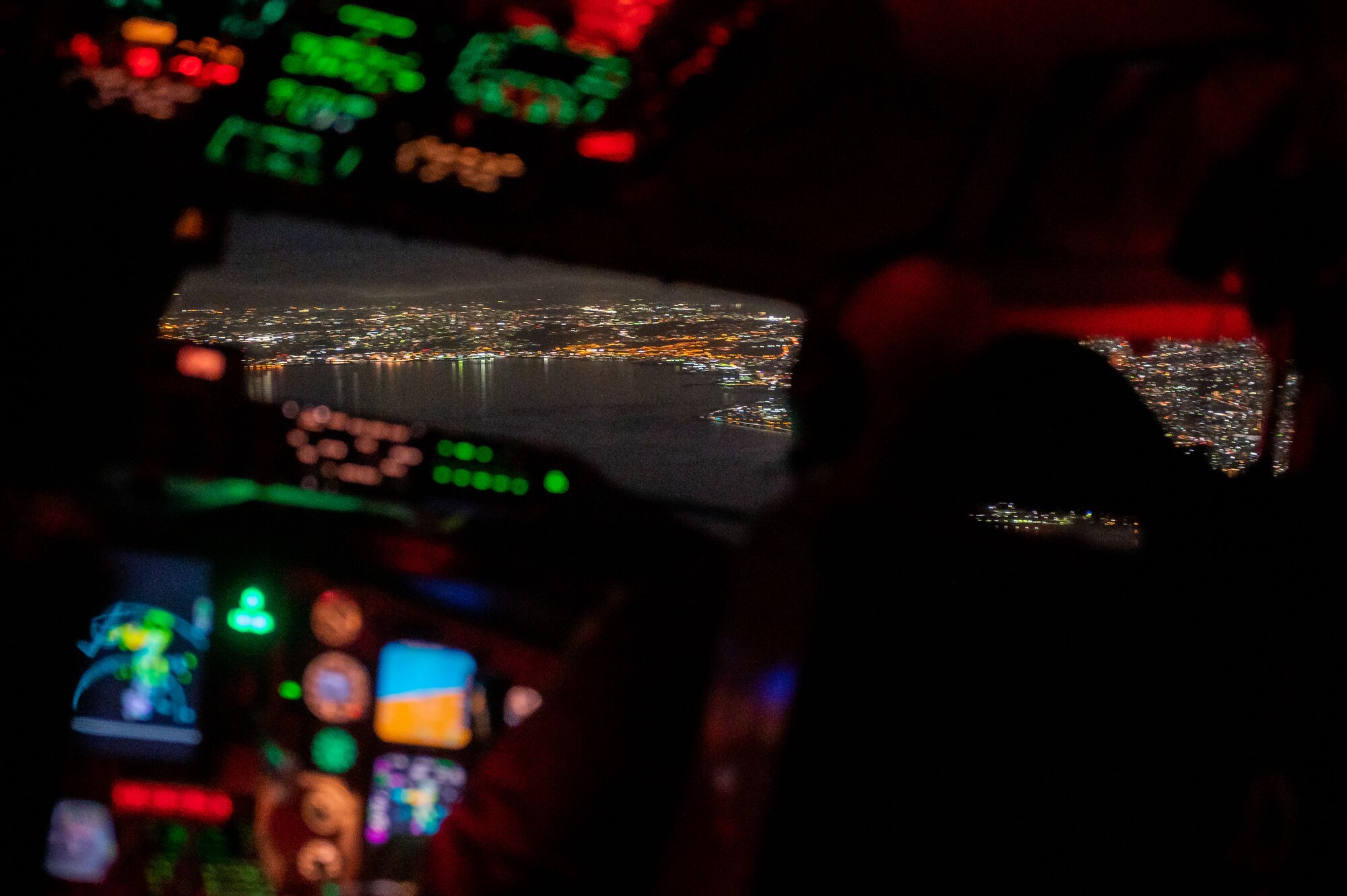 A pilot steers a plane over a the water into the city