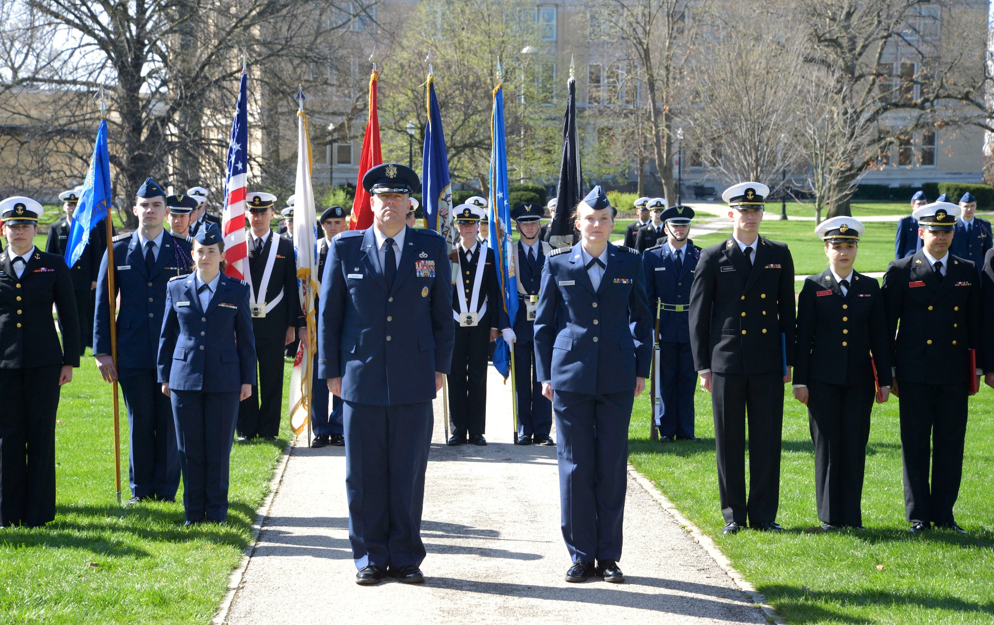 Col. Patrick Miller, 88th Air Base Wing and Wright-Patterson Air Force Base commander, stands at attention along with cadets of Detachment 645 as the Tri-Service Parade concludes April 14, 2022 at Ohio State University. The Tri-Service Parade has been a tradition at Ohio State University since 1916, and allows several cadets and midshipmen to receive scholarship awards from generous donors. (U.S. Air Force photo by Darrius Parker)