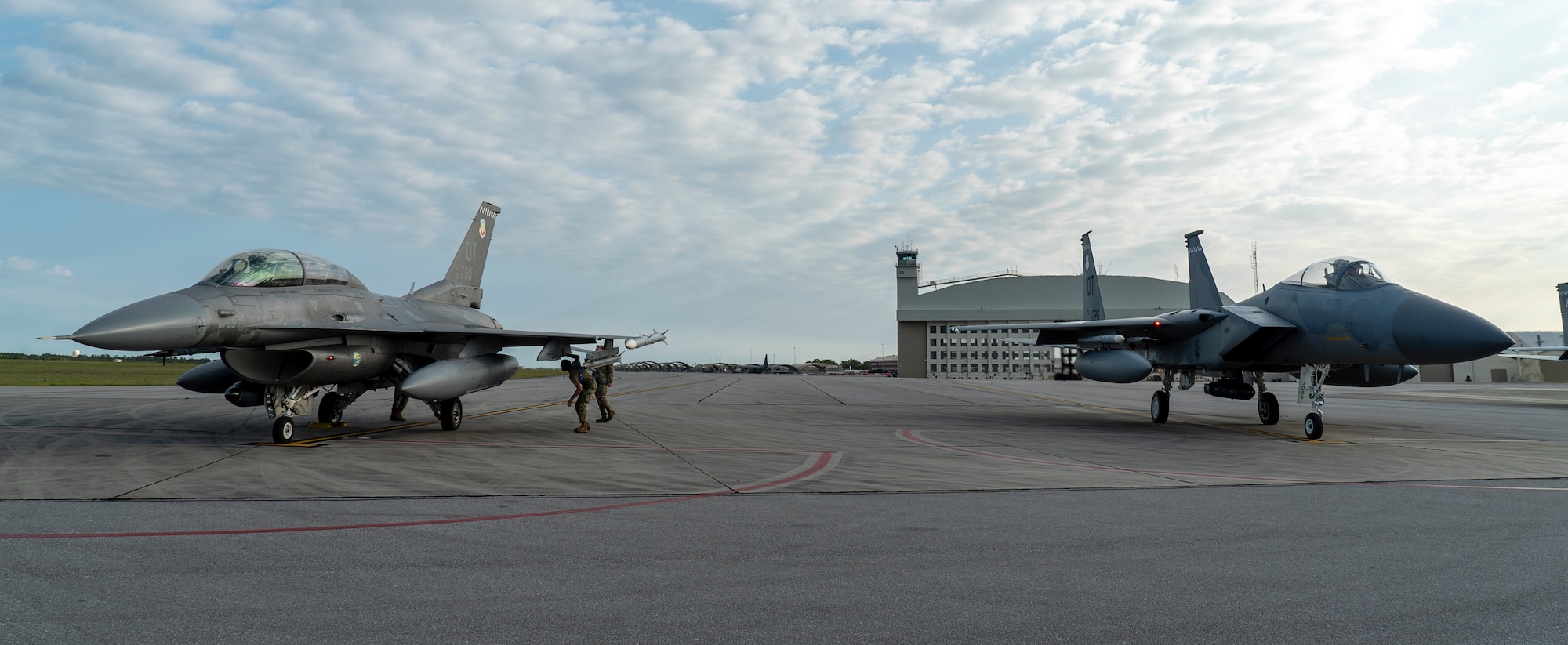 An F-16 and F-15 assigned to Eglin Air Force Base, Florida, prepare to test a datalink between two infrared search and track (IRST) pods, April 7, 2022.  The successful flight test demonstrated the ability for two dissimilar aircraft to passively range a fighter target using IRST. (U.S. Air Force photo)