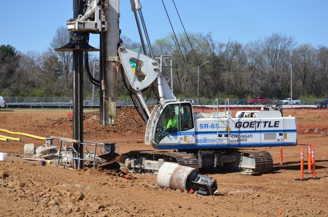 A contractor uses a drill rig to remove soil overburden March 28. The drill rig is also being used to remove bedrock as part of forming drilled piers.