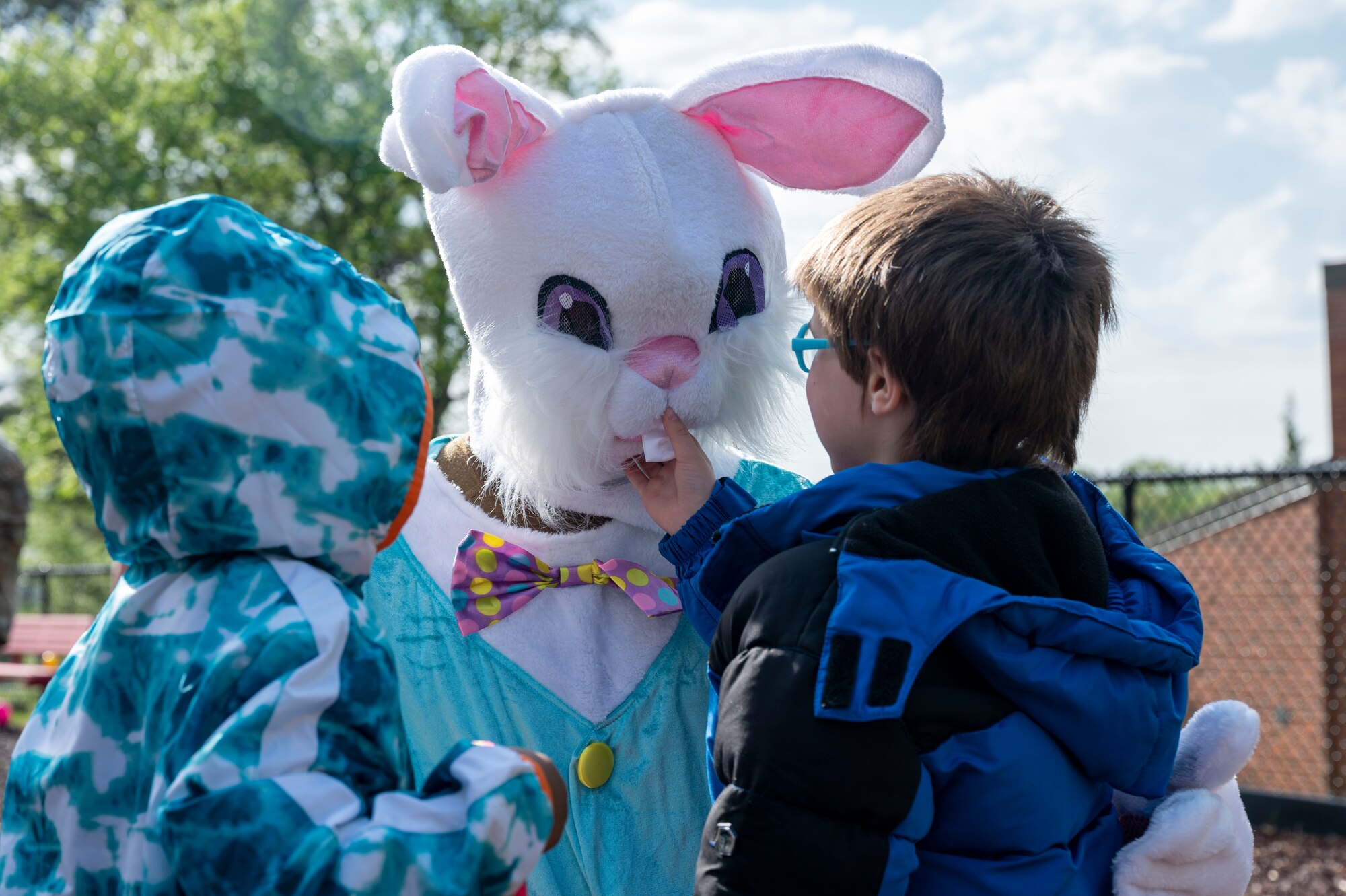 Students from the Arkansas School for the Blind and Visually Impaired play with the Easter bunny during an egg hunt