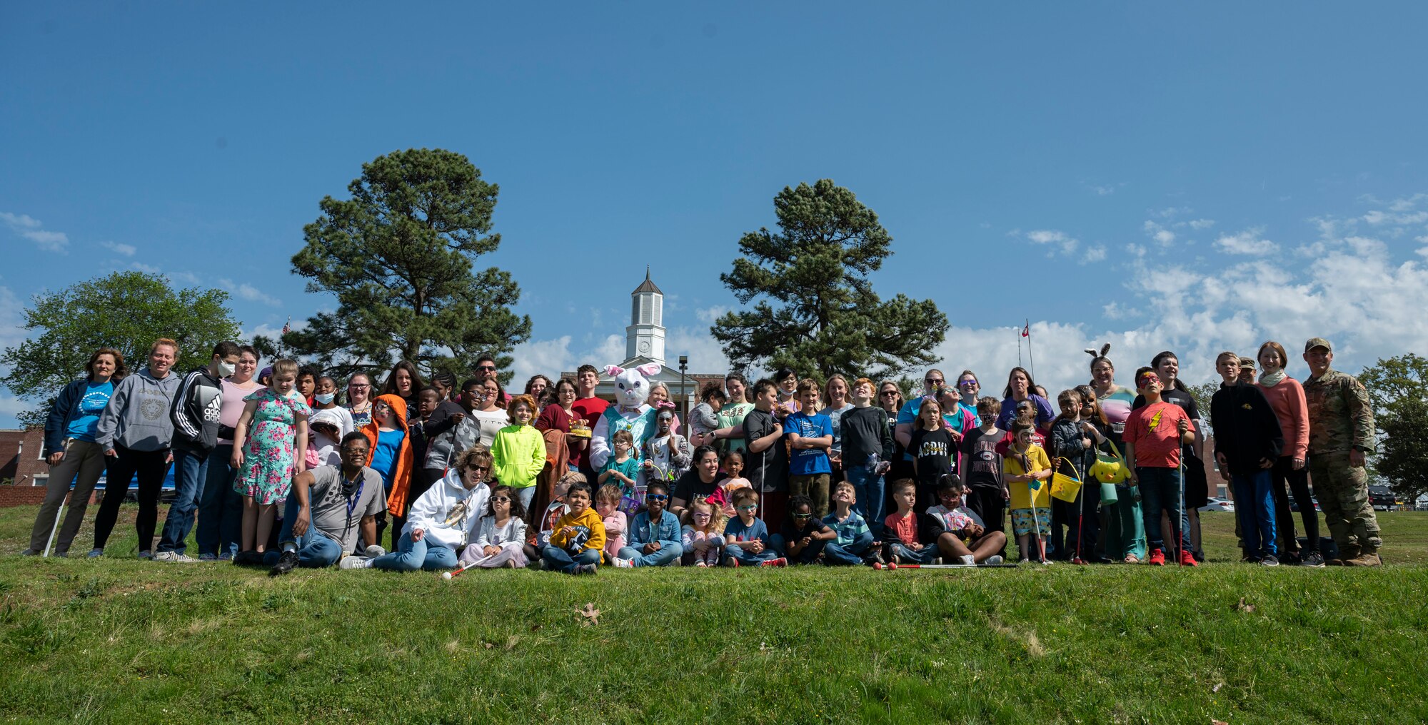 Airmen with the 19th Civil Engineer Squadron explosive ordnance disposal flight pose for a photo with students and staff from Arkansas School for the Blind and Visually Impaired