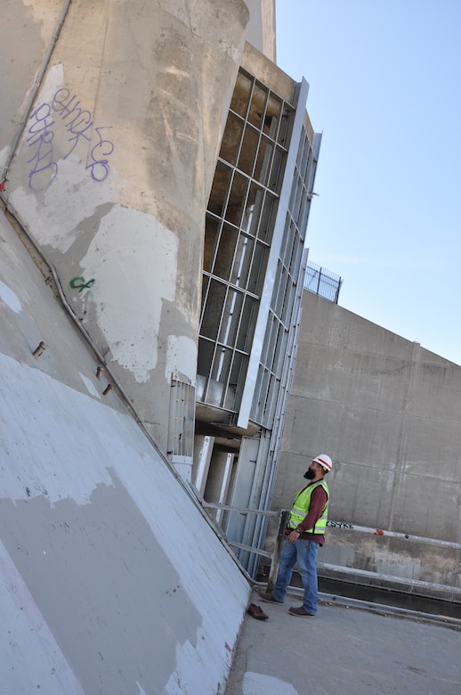 Jesse Fierros, lead for operations and maintenance for the Los Angeles County Drainage Area, U.S. Army Corps of Engineers Los Angeles District, surveys the trash rack of the Sepulveda Dam March 22 in Van Nuys, California.