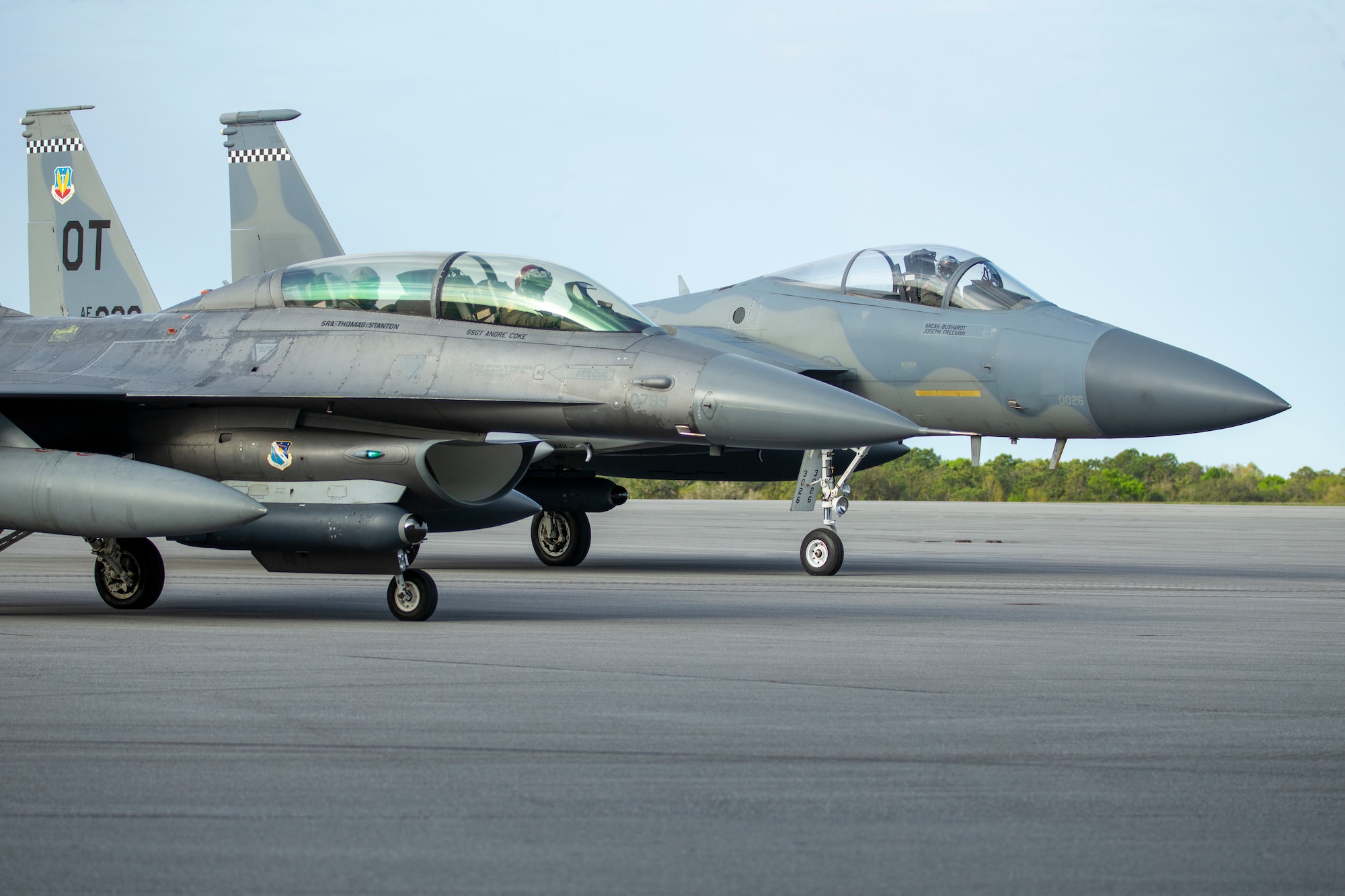 An F-16 and F-15 assigned to Eglin Air Force Base, Florida, prepare to test a datalink between two infrared search and track (IRST) pods, April 7, 2022.  The successful flight test demonstrated the ability for two dissimilar aircraft to passively range a fighter target using IRST. (U.S. Air Force photo)