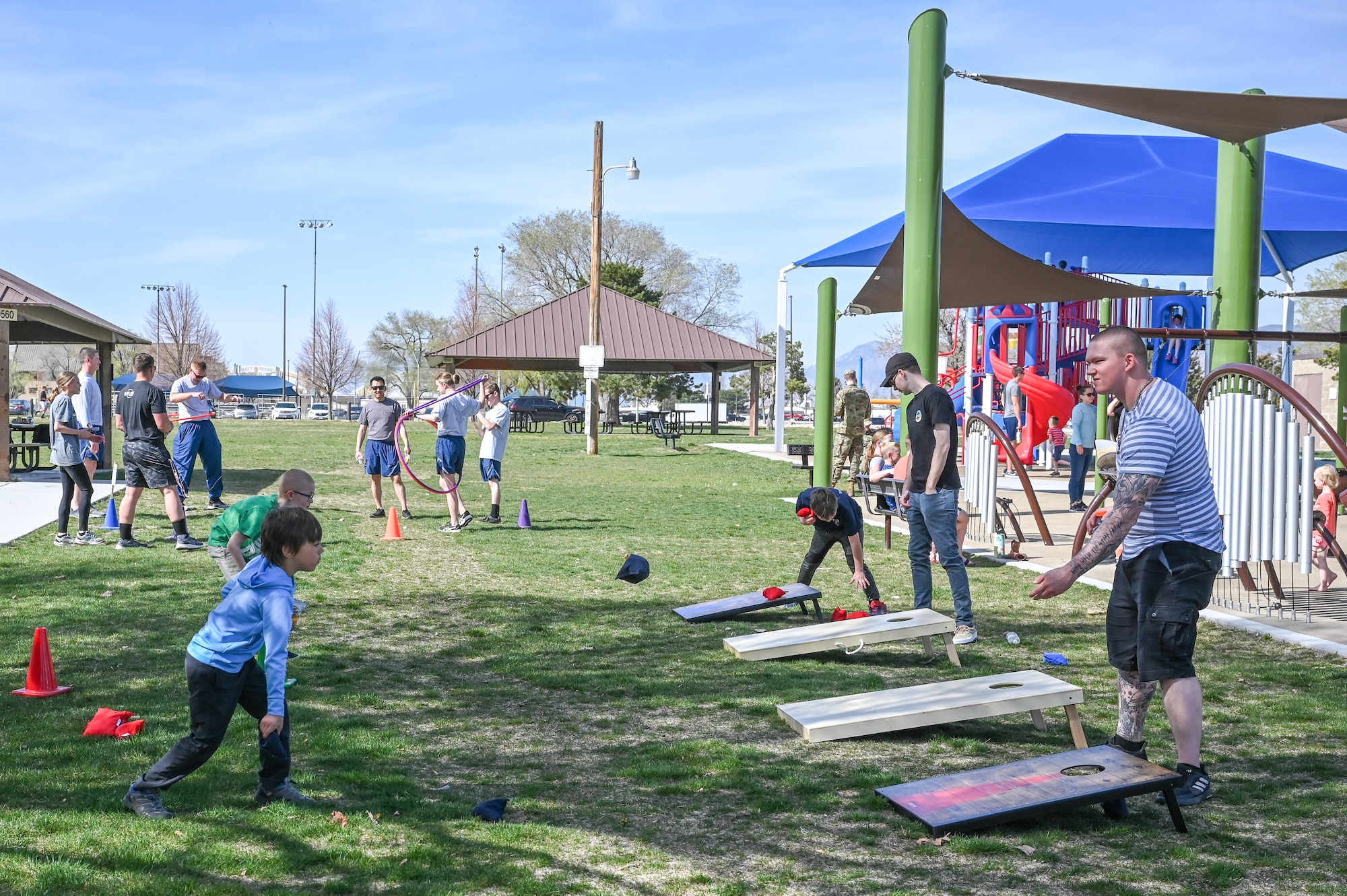 Families play the cornhole game during the “Show Up for Military Families” field day April 19, 2022, at Hill Air Force Base, Utah.