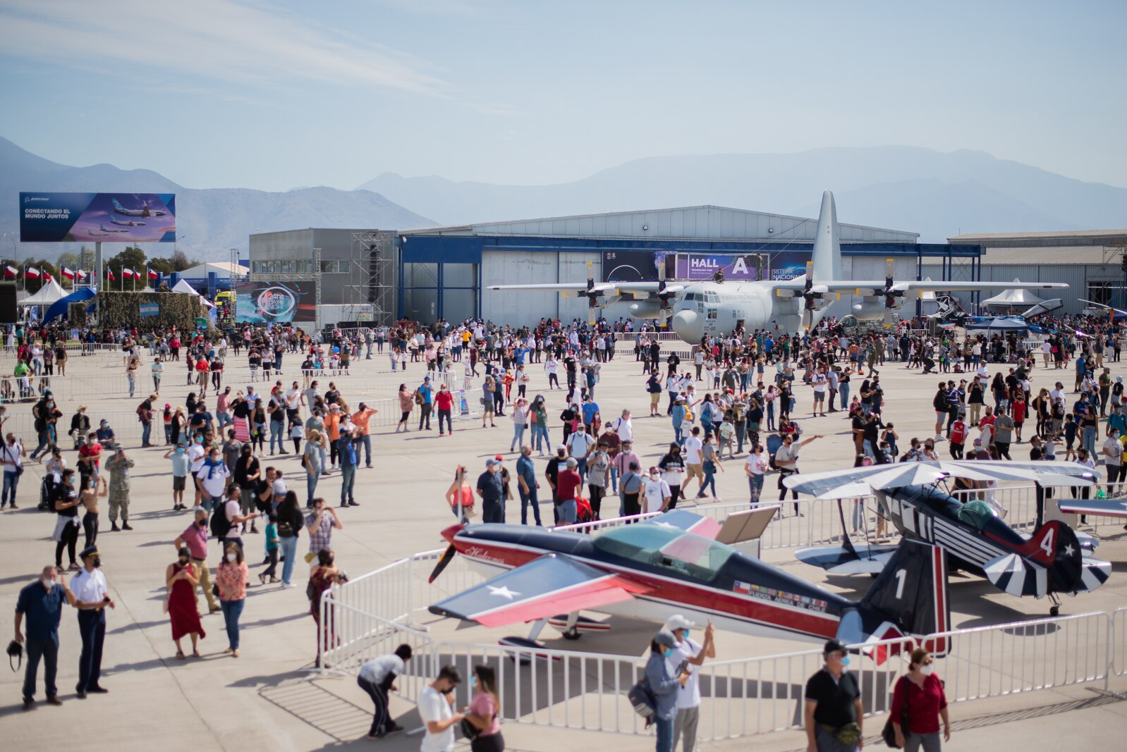 Visitors crowd aircraft statics FIDAE Air Show.